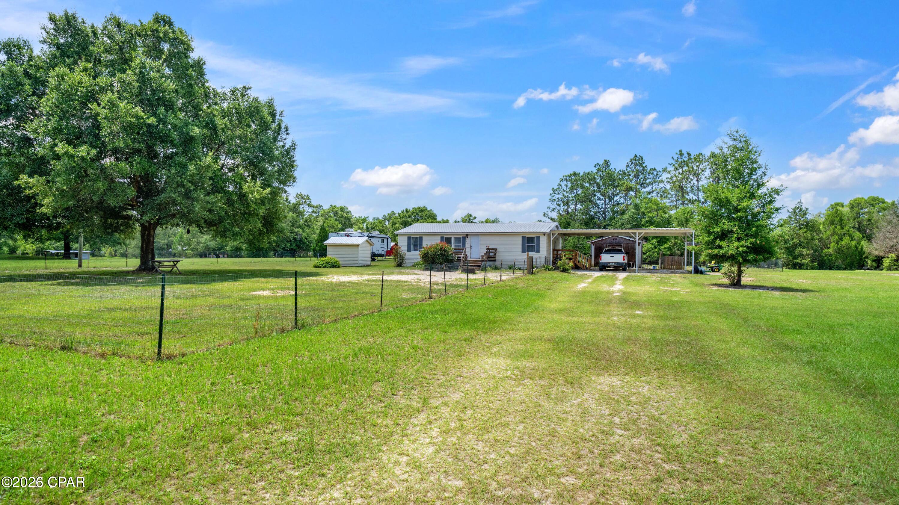 **'CURRENTLY UNDER CONTRACT, SELLER WILL CONSIDER BACKUP OFFERS'** Enjoy the freedom of country living with this well-maintained 3-bedroom, 2-bath manufactured home situated on 2.41 cleared acres in Bay County. Otter Creek access is only 2 blocks away! Built in 1999 and offering 1,188 square feet of comfortable living space, this property provides plenty of room to spread out while still being conveniently located to nearby amenities.
Major updates have already been completed, including a durable metal roof installed in 2018, a full HVAC replacement in 2020, and a new water heater in 2026. The home is serviced by a private well and septic system, offering added independence and lower utility costs.
The fully usable acreage provides endless possibilities for gardening, recreation, pets, or future improvements. Fenced areas in both the front and back yards create a secure space for children and animals while maintaining the property's open feel. Whether you're looking for a primary residence, a peaceful retreat, or an affordable property with acreage, this Bay County home offers a rare combination of value, privacy, and functionality.
Don't miss your opportunity to own over two cleared acres with key updates already in place--schedule your showing today! *Pool and RV's do not convey* ****All measurements and information is deemed reliable, and should be verified by buyer or buyer's agent if important.**