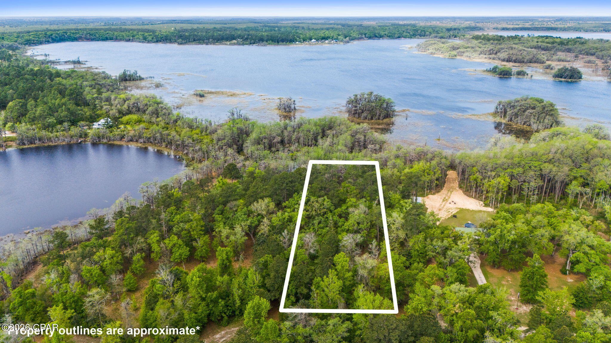 Very peaceful 1.58 acre waterfront property  on Lucas Lake located inside the gated community of Paradise Lakes. If you are looking for a serene, beautiful place to build a home this is it! Single Family or Manufactured Homes are allowed. Underground utilities are in place.  There is also a community boat ramp with access to Dunford Lake. It is restricted to boats of up to 25 HP and a maximum speed of 15 mph. HOA fees are $100 per year.  Don't miss taking a look at this gem of a community. Must have gate code to enter.