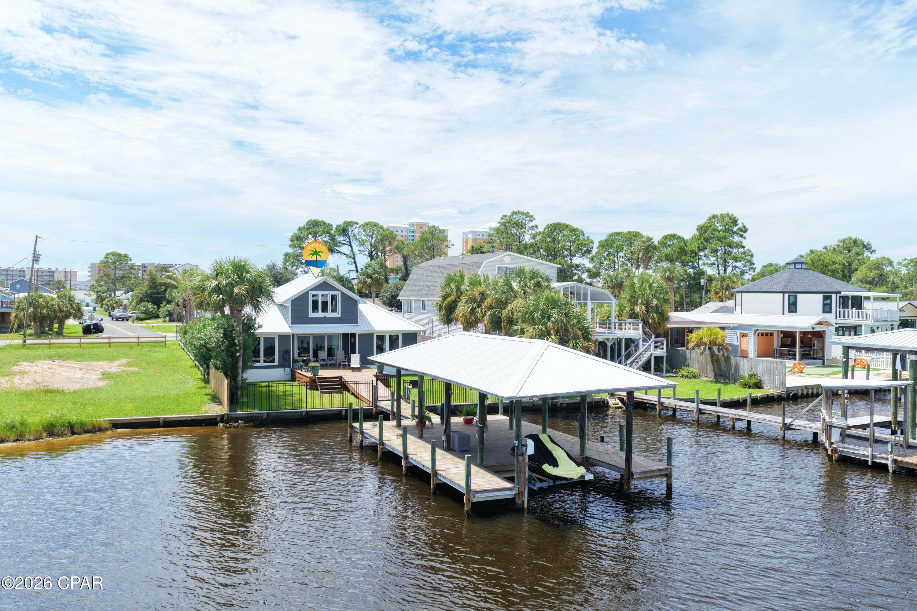 BRING YOUR BOAT! 3-Br 2.5-Ba house with a 14'x36' covered boat dock with water, electricity and jet ski lift.  Totally updated with all new hurricane windows and doors, tri[ple opening sliding door, new bathrooms and kitchen,  the upstairs bedroom currently used as a man cave with a bar sink, wine cooler, and 1/2 Bath. *New A/C units, sprinkler system w/well pump.   just **4 blocks to the sugar-white sands of the beach**. Build your dream home or getaway retreat on protected lagoon waters with Gulf of America access just minutes away.

This lot offers a peaceful, private setting on the water with a new boat dock already in place, fresh split-rail fence lining the frontage. Deep, calm lagoon water is perfect for kayaking, fishing, or launching a boat right from your own backyard. A public boat ramp just down the street makes it easy to get out on the water, and you're close to some of the best restaurants on the east end.
 
The lagoon front lot next door is for sale  at $685k (mls# 793039)
Live in this house while you build a new one. Can do Vacation Rentals.

 ** Rare opportunity to own two lagoon-front properties side by side**
