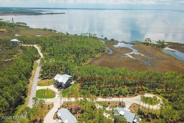 This nearly 3/4-acre vacant lot offers expansive, direct southeastern views of West Bay and stunning sunrises over the water. Located in the highly sought-after community of RiverCamps, this property is ready for you to design and build your custom dream home. RiverCamps is an exclusive, 1,500-acre gated waterfront community where 1,000 acres are dedicated to nature conservation, ensuring a quiet environment with less than 450 total homesites. The location offers the perfect balance of privacy and convenience, sitting just 10 minutes from the airport and 15 minutes from the famous white-sand beaches of Panama City Beach.

As an owner, you will enjoy premium, resort-style amenities right in your neighborhood. The community features a boat ramp, day-use boat slips, and dry-boat storage for easy water access, alongside a fitness center and a zero-entry swimming pool. For outdoor enthusiasts, the neighborhood provides seven miles of hiking and biking trails, plus unlimited use of community kayaks, canoes, paddleboards, and bicycles.