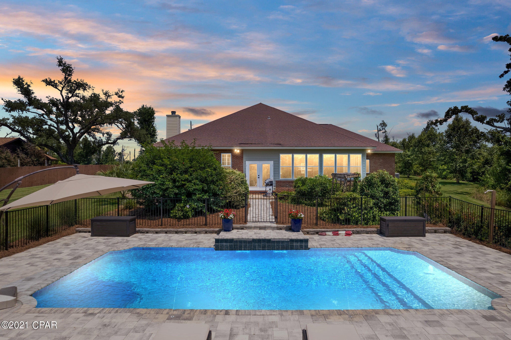 Welcome to this gorgeous move-in ready home on a 1.2 acre lot on Beatty Bayou. Relax outside by the pool or enjoy evenings by the fire pit overlooking the bayou that leads to the Bay and directly to the Gulf. This home was custom built with 10ft ceilings, crown molding, and upgraded antique lighting fixtures throughout the home. There are so many features that make this home special including surround sound wiring in the ceiling of the Master bedroom and throughout most of the house. The oversized Master bedroom and bath feature a large jacuzzi tub, dual vanity, and ceiling fans offering a cool, spacious area for personal enjoyment. The charming mantle in the formal living room was handcrafted in the early 1900s. There is a utility sink and plenty of counter space in the laundry room. Enjoy the comfy built-in swing in the spacious Florida room that opens to a walkway leading to the fenced custom-designed pool area. The Florida room is heated and cooled and features large open windows that allow for relaxing, enjoyable afternoons. The lawn is immaculate with Birch, Crepe Myrtle, and Live Oak trees that were planted in 2019. An RV power hookup is located on the side of the home. This home is on a dead-end street creating low traffic. Additional safety features include the Nest Doorbell and an August automatic lock on the front door that unlocks with an App. Lynn Haven has some of the top schools in the area including Bay Haven, Mosley, Deer Point Elementary, and Mowat Middle School. It's an easy commute to area military bases and located near Gulf Coast Regional Medical Center, the airport, and convenient to shopping and dining. Call today to schedule your private tour of this incredible home! **Pets negotiable with non-refundable $500 pet fee.