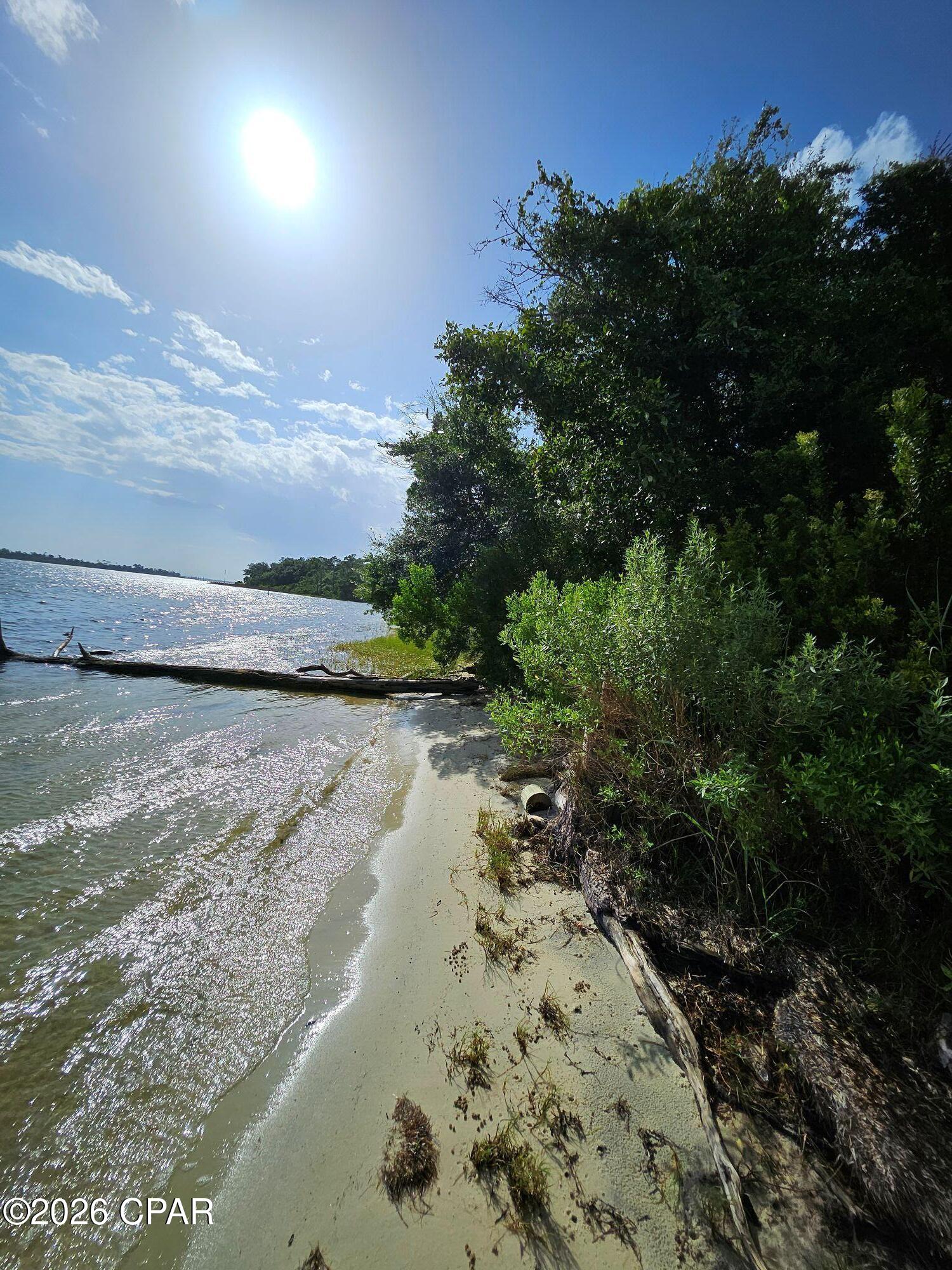 Almost a half acre of beautiful unobstructed open Bay views.  Large lot that views south  East as well as S West. This parcel is big enough to build a large private home and potential guest house. Heavily wooded  to keep the property as private as you choose.  The property has been owned by the same family for many years so no survey is available.. A dock can be constructed on the property for a boat.