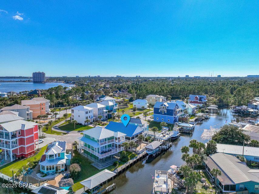 Stunning Waterfront Home with Gulf Access and Deep Water Boating Amenities. Don't miss this incredible opportunity to own a newly renovated waterfront retreat with direct access to the Gulf! Situated in a secluded, gated community, this home is a boater's paradise, complete with a deep-water boat slip and boathouse. Step outside to enjoy Florida's fabulous weather on two oversized, southern-style screened porchesâ”perfect for entertaining family and friends. Inside, the home features exquisite finishes, including light sand-colored quartz countertops in the kitchen and bathrooms, complemented by immaculate white cabinetry and modern gold hardware for a clean, sophisticated look.
Elegant, opaque white tiled showers and a convenient outdoor shower provide multiple options to refresh after a day at the beach or on the water. Pale wide-plank wood tile flooring runs seamlessly throughout the home, adding warmth against the charming white shiplap walls. Modern, sleek windows and doors introduce a touch of metropolitan flair, while designer lighting mimics the natural outdoor ambiance. With two separate living areas one downstairs and one upstairs this home offers the flexibility for kids to hang out downstairs while adults relax and socialize upstairs. Conveniently located less than 10 miles from Pier Park, you'll have access to excellent dining, shopping, and entertainment. Additional highlights include a climate-controlled garage, making this home as functional as it is beautiful.This exceptional waterfront property truly has it all. Schedule your private tour today and make it your coastal oasis!