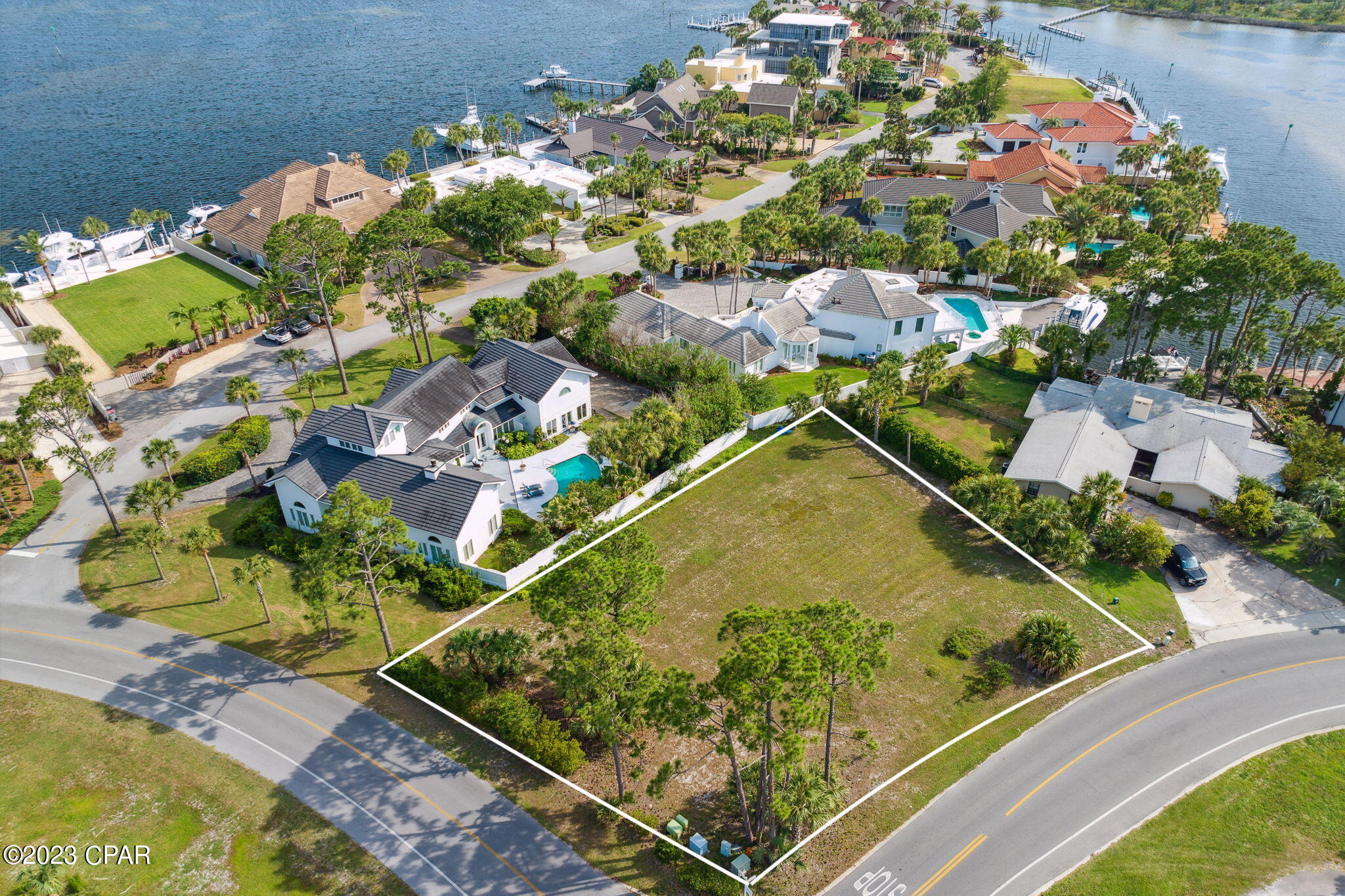 UNDER CONTRACT-SELLER MAY ACCEPT BACK UP OFFERS. Corner Lot Available To Build Your Dream House. Second & Third Story Could Have Water Views.