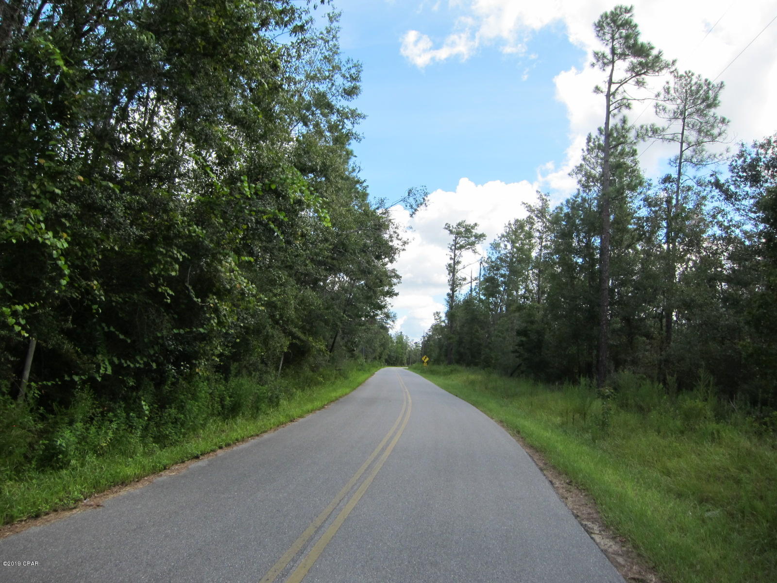 Located directly across the street from the beautiful Compass lake, this property has limitless possibilities.  Clear you area to build the house of your dreams or just have a place just down from the public boat landing to enjoy on the weekends.  Plenty of room to sprawl out on this 7+ acre parcel of land.  Call today.  Owner/broker - priced to sell!!  Seller Financing available.