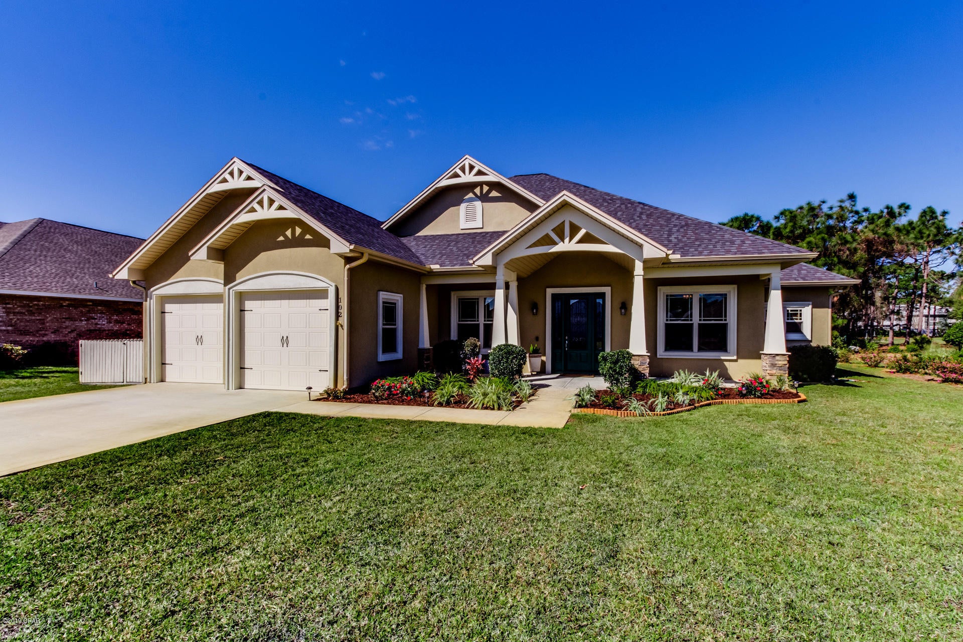Beautiful Craftsman home in prestigious Glades subdivision. 4 bed, 2 ½ bath open/split floor plan with 10' ceilings. Wide crown molding every room, 8 foot doors, trey ceilings in formal dining, great room and master. Gourmet kitchen with stainless Euro hood over smooth top island. Roomy 42'' solid cherry, soft-close cabinets, granite counter tops throughout, brushed nickel faucets, large pantry and stainless microwave drawer. Spacious laundry complete with folding area and anteroom. Master suite with sitting area, walk-in closet, separate vanities, tiled shower and garden tub. Large screened lanai and outside patio, 2 x 6 exterior walls. 2 zone AC. Alarm system & Ring doorbell. Patio TV stays.