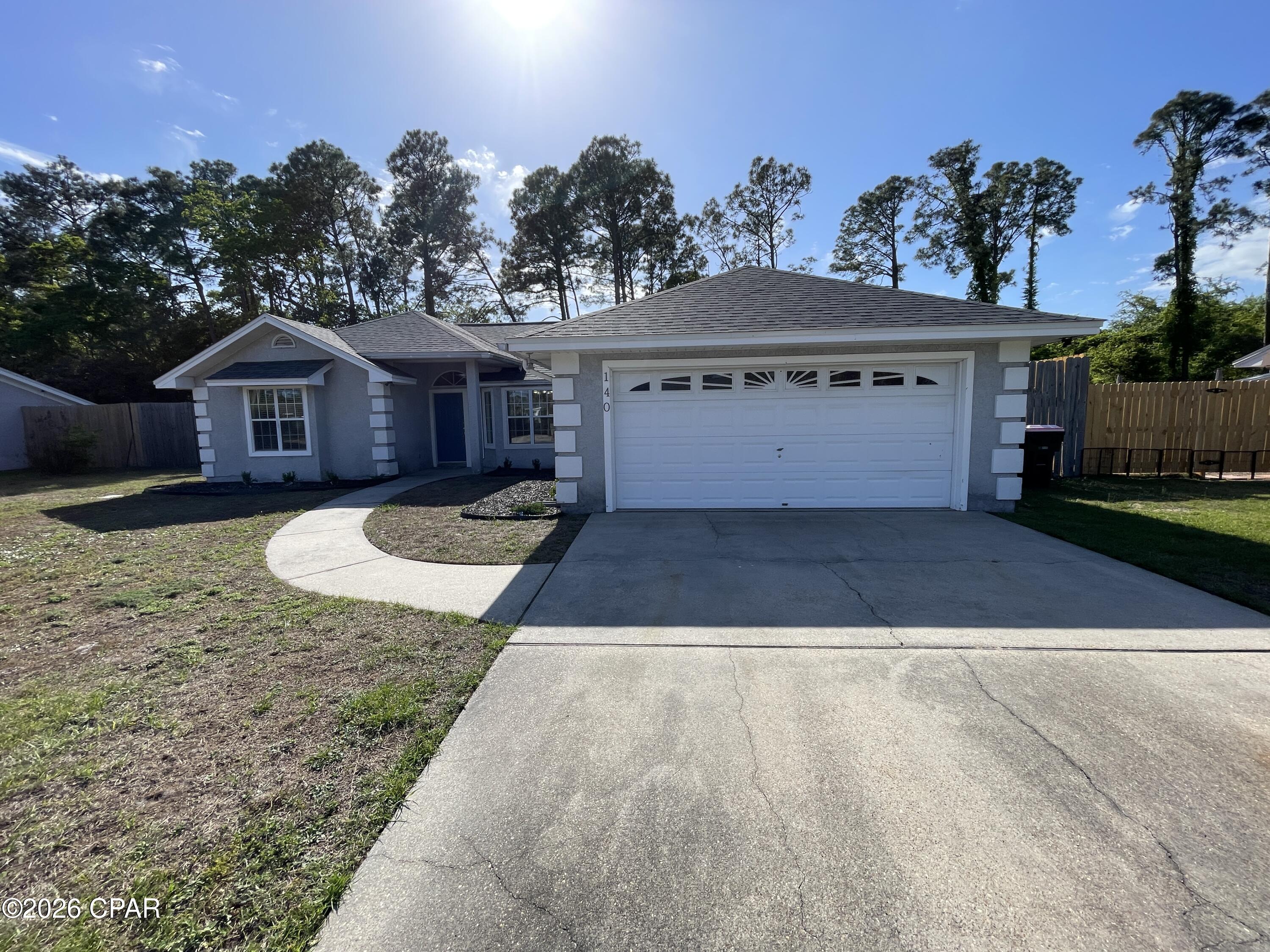For Lease - A welcoming 3-bedroom, 2-bath home in the desirable Treasure Palms neighborhood of Panama City Beach. This well-maintained property features an updated kitchen with granite countertops, stainless steel appliances, ample cabinet storage, and a cozy breakfast nook. The kitchen includes a refrigerator with ice maker, stove top, oven, and dishwasher. A formal dining room opens to the living area, highlighted by a stacked-stone wood-burning fireplace for added charm. The split bedroom layout offers two guest bedrooms with a shared hallway bath featuring a tub/shower combination, while the spacious master suite includes a jetted tub, walk-in shower, walk-in closet, and private toilet room. Enjoy a large, fenced backyard with a double gate for boat storage and a covered back porch perfect for relaxing outdoors. Inside laundry room just off the two-car garage. Conveniently located near the Navy base, Publix, local restaurants, and the beach, this home offers comfort and coastal convenience in a quiet community. Shed does not convey with property. Sprinkler meter on same meter as house. *No pets allowed. *Backyard storage shed does not convey with the rental.