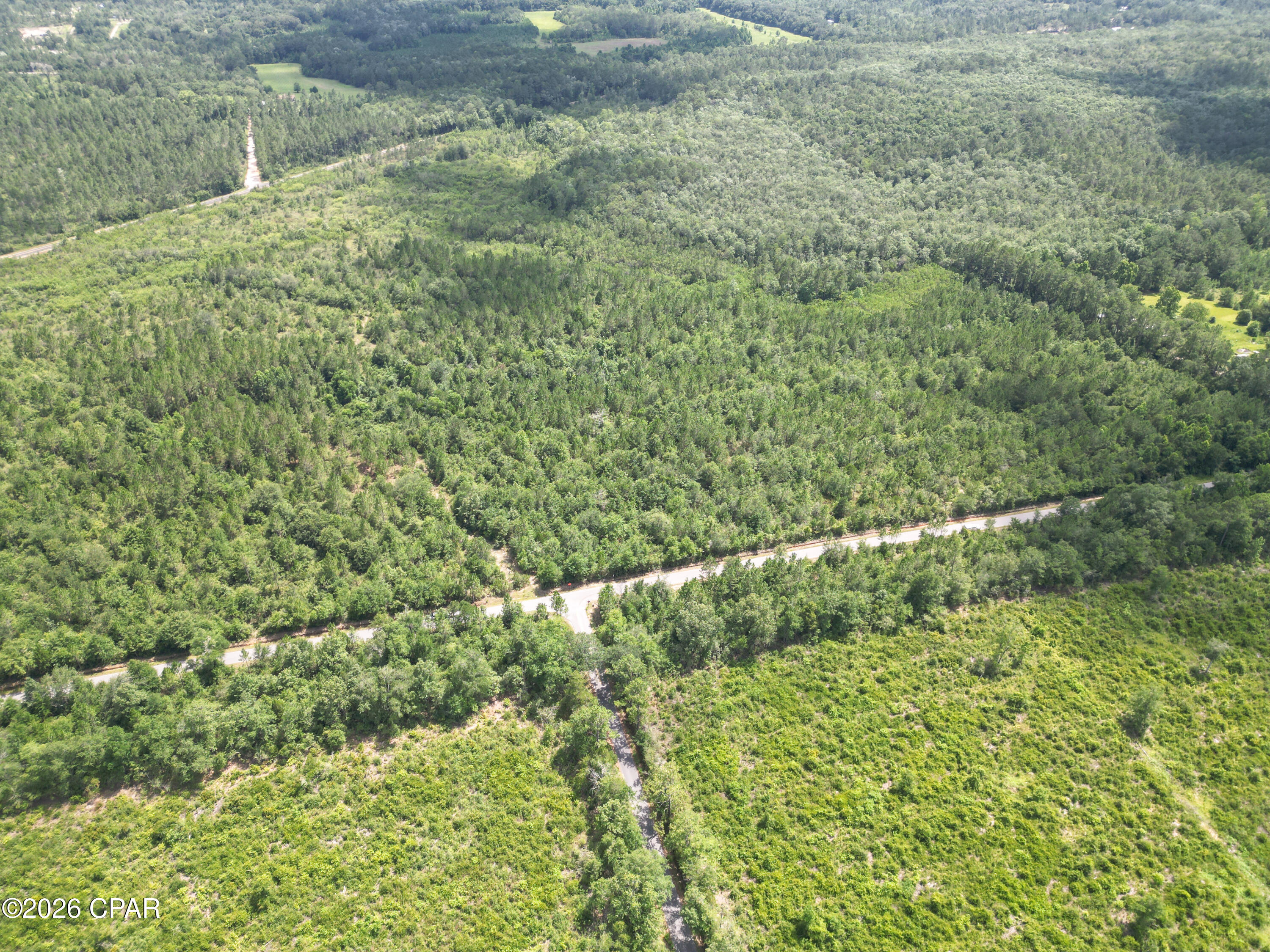 If you're looking for more than just another piece of land, you'll want to take a closer look at Lot 9 in Pine Ridge Estates. This high and dry 9.4 ± acre wooded parcel offers the ideal combination of privacy, natural beauty, and convenient access, making it an excellent place to build, invest, or simply enjoy the North Florida lifestyle. Pine Ridge Estates is a newly established acreage community in Washington County featuring homesites ranging from approximately 7 to 25.5 acres. Designed for those who appreciate open space and a slower pace of life, the community offers the opportunity to enjoy country living without feeling isolated. Here you'll find room to breathe, space to grow, and the freedom to create the lifestyle you've always wanted.
Surrounded by mature pines and hardwoods, this parcel provides both privacy and natural beauty. A homesite has already been cleared, providing a great head start for your future home. Whether you're dreaming of building your forever home, starting a hobby farm, keeping a few horses, planting a garden, or simply having room to spread out and enjoy the outdoors, this property offers the flexibility you've been searching for. Deer, turkey, and other small game are frequently seen throughout the area, adding to the peaceful setting. Electricity is available at the road, making the property even more build-ready.
Conveniently located just 4.5 miles from Interstate 10 and 2.5 miles from Highway 79, the property offers easy access to nearby towns and amenities. You're only about 40 miles from Panama City Beach, where 27 miles of sugar-white sand, emerald-green Gulf waters, waterfront restaurants, shopping, entertainment, fishing, and boating make every visit feel like a getaway. Whether you're spending the day on the beach, enjoying fresh seafood, or watching the sunset over the Gulf, the coast is always within easy reach.
Outdoor recreation is one of the many reasons people are drawn to this part of North Florida. Spend your weekends exploring the crystal-clear waters of Cypress Springs on Holmes Creek, kayaking along Holmes Creek, fishing nearby rivers and lakes, or enjoying the area's many parks and wildlife management areas. Golf enthusiasts will appreciate being just 15 miles from the future Old Shores community--an exciting new destination planned to feature a world class golf course. As this premier development takes shape, homeowners at Pine Ridge Estates will be conveniently located to one of Northwest Florida's most anticipated new recreational spots while still enjoying the peace and privacy of country living.
Owning acreage is about more than where you live--it's about how you live. It's having the freedom to build the home you want, enjoy the outdoors, and appreciate a little extra space. Whether you're putting down roots, creating a weekend retreat, or investing in your future, Lot 9 offers an opportunity to enjoy the best of North Florida. Additional homesites are available in Pine Ridge Estates, with parcels ranging from approximately 7 to 25.5 acres. Discover the freedom of owning acreage in one of North Florida's most beautiful settings--where peaceful country living and outdoor adventure come together. Call today for more information.
Key Features:
• Frontage on Bess Nook Road
• Located in the newly established Pine Ridge Estates
• Mature pines and hardwoods
• Abundant deer, turkey, and other native wildlife
• Electricity available at the road
• Ideal for a custom home, hobby farm, horses, or recreational use
• Approximately 4.5 miles to Interstate 10
• Approximately 2.5 miles to Highway 79
• Approximately 10 miles to Cypress Springs on Holmes Creek
• Approximately 15 miles to the future Old Shores community
• Approximately 40 miles to Panama City Beach