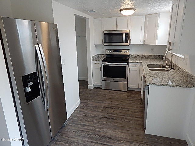 COMPLETELY REMODELED, CENTRALLY LOCATED Very short commute to Navy Base & Tyndall AFB - New Windows, New interior/Exterior Doors and Windows, New Paint, New lighting Fixtures, New beautiful vinyl plank flooring throughout! New Cabinets, New Granite Counters, ALL New Stainless Steel appliances. Dbl Door Refrigerator w/Ice and water in the door, glass top - self cleaning stove/oven, new dishwasher and Hood Microwave. Washer and Dryer Hook Ups. Awesome 1'' steps that have been stained a light grey. NO CARPET ANYWHERE. Inside cats may be considered with Non Refundable Pet Fee