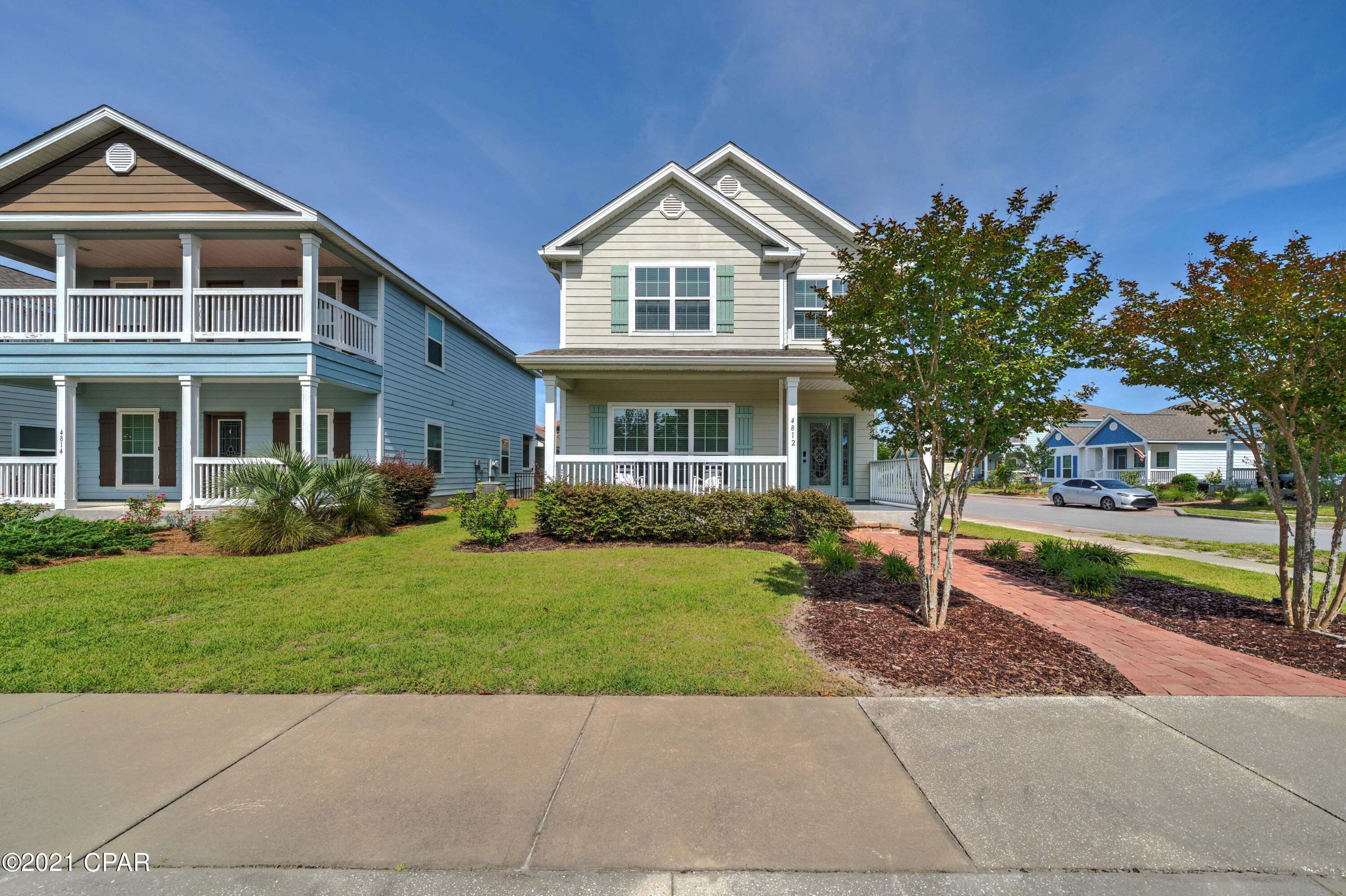 CURRENTLY UNDER CONTRACT, SELLER ACCEPTING BACKUP OFFERS'Move in ready! Looking for 4 bedrooms in a gated neighborhood in Panama City Beach? You found it! Open the door and you will want to stay in this 4 bedroom, 2.5 bath home that looks like a model home! Perfect location on a corner lot, easy to walk to the neighborhood pool and gym and your community dock. Great floor plan, courtyard with pavers in the backyard - perfect to grill or hang out.  New paint inside and out, custom built in cabinet in the family room, hardwood floors and a tankless gas hot water heater are just a few of the features.  Welcoming front porch, fenced in yard and 2 car garage complete this well maintained home. Magnolia Bay Club is located on St Andrews Bay close to Coastal Systems, great shopping and schools!