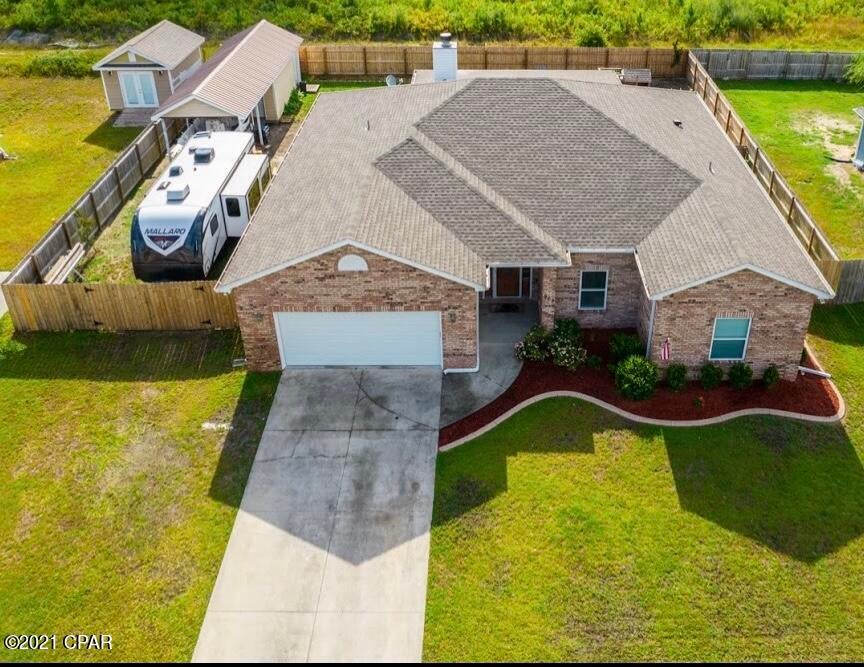 UNDER CONTRACT- TAKING BACK UP OFFERS! This all brick custom home is a rare find! It has a rustic contemporary design that is inviting and warm! Beautiful quartz countertops and lots of storage and cabinets are built into this kitchen with a breakfast bar that overlooks the dining area.  A wood burning fireplace with a custom mantle is the centerpiece for the spacious  open family room. The arched entryways and wood ceilings on the back porch are just a few of the finishing touches this unique home has to offer. The lighting and ceiling fans are designer and convey with the home. The garage has climate controlled storage above. The fenced backyard has an additional  12x40  carport and shed. Call today to schedule a tour of your future home!