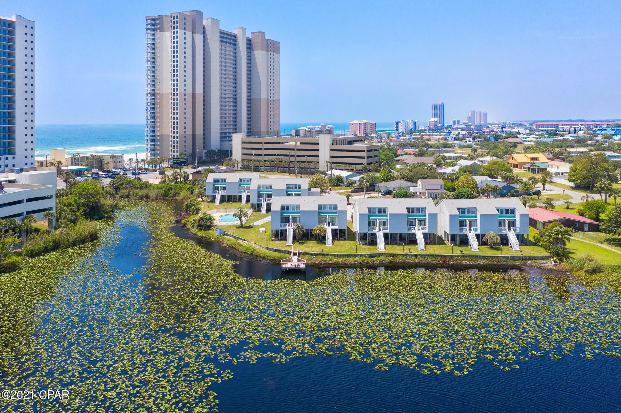 Welcome to your new Beach Condo!  This ground-level, lakefront condo is located right across the street from the Gulf of Mexico on the popular West End of Panama City Beach! This studio beach condo is perfect for a second home, vacation rental, or for affordable long term efficiency living!  You really can have it all here and not break the bank! Sit on your private back patio and watch stunning sunsets over the lake, or enjoy a dip in the community pool!  Lullwater Lake Beach Condominiums is a low density complex with NO elevators! Owners have ample parking, a lakefront community pool, bbq grills, and the world's most beautiful beaches are only a short walk away!  This unit is tastefully furnished, flat surface countertops, Luxury Vinyl Plank floors, updated bathroom vanity dishwasher, refrigerator, stove, lovely dining area, open concept living, and comes furnished and rental ready. Call today to schedule your private showing.