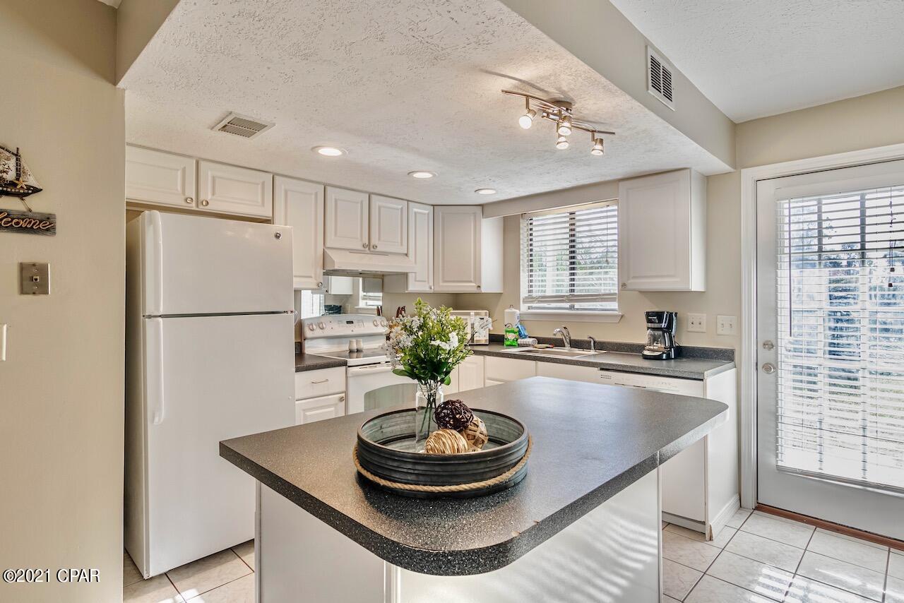 OPEN, BRIGHT & INVITING - MOVE IN READY - FURNISHED - SHORT TERM RENTAL under $300K! Recently UPDATED & backs to a Picturesque WATER CANAL with Extraordinary VIEWS & Captivating SUNSETS! Highly desired Unit, located closer to the BACK PRIVATE GATE, just a WALK away from the BEACH! RECENT UPDATES: New Roof, 2020; Luxurious LVP on 2nd Floor (old carpet/tile removed, easy to clean); ALL NEW MATCHING Fixtures, Recessed Lighting, Ceiling Fans, Furniture (including Leather Couch) TV's, Décor & Tropical Landscaping added in the back, FRESH & LIKE NEW! Owners/guests enjoy the 11 pools (5 heated) & private Beach access! Comes w/2 Assigned Parking Spaces in Front of Unit! LOW HOA & CONVENIENT to EVERYTHING for the PERFECT VACATION GETAWAY, while making GREAT SEASONAL CASH FLOW! Schedule ASAP!
