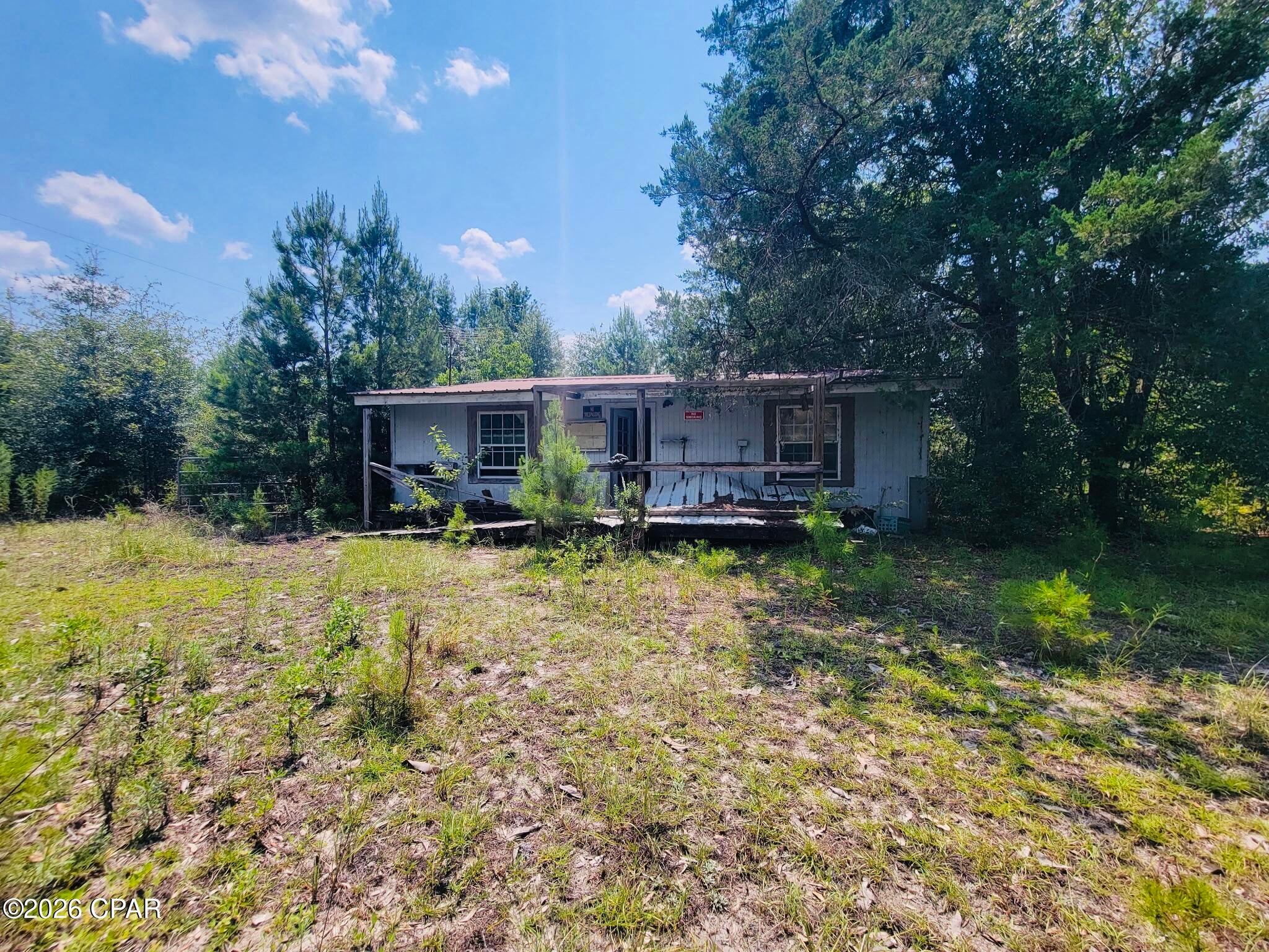 Situated on nearly a 1/2-acre lot, this property offers an excellent opportunity for investors, builders, or buyers looking to create their dream home. The existing residence is in distressed condition and will require significant renovation or demolition, making this a true value-in-the-land opportunity.

Located just moments from beautiful Lake McKenzie, you'll enjoy the benefits of peaceful country living with easy access to fishing, boating, and outdoor recreation. 

Conveniently positioned approximately one hour from both Panama City and Tallahassee.