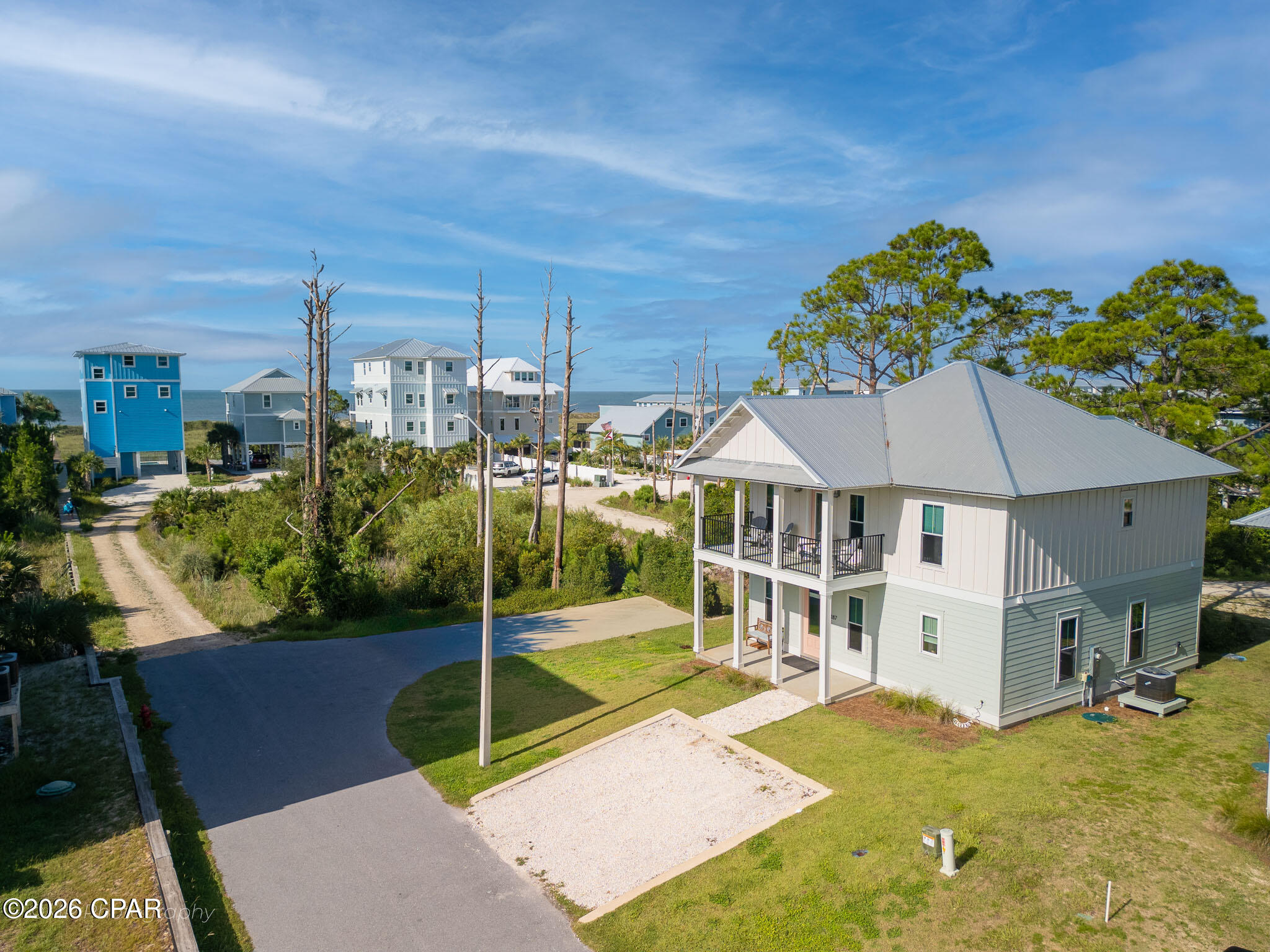 Just steps from the sugar white sands of Cape San Blas, 187 Tortuga Trail offers a rare combination of new construction quality and an unbeatable location. Built in 2023 by Ben Wortman Construction, this thoughtfully designed home showcases classic coastal cottage architecture, with double stacked covered porches and standing seam metal roofing setting the tone from the curb. Inside, approximately 1,998 square feet unfold across four bedrooms and three full and a half bathrooms, with two separate living rooms on the main and second floors that give family and guests room to spread out after a day at the beach. The main level offers an open concept living, dining and kitchen layout finished with quartz countertops and stainless steel appliances, while the primary suite features a vaulted ceiling and a spa style bathroom with a freestanding soaking tub and frameless glass shower. The home is being sold fully furnished and turnkey ready, with no homeowners association. The home resides in Flood Zone X, so flood insurance is not a lender requirement, making ownership as simple as it is rewarding.
Beach access is just steps away, and the coastal lifestyle extends well beyond the shoreline. A short walk or bike ride brings you to Salinas Park, where bay access, boardwalks, picnic pavilions, a playground and pickleball courts create an easy gathering spot for neighbors and visitors alike. Just to the north, St. Joseph Peninsula State Park protects miles of undeveloped dunes and pine flatwoods, with hiking trails, prime birdwatching and some of the most pristine beaches on the Gulf Coast, regularly ranked among the best in the country.
Whether used as a primary residence, second home or investment property, 187 Tortuga Trail delivers the character, craftsmanship and coastal setting that define life on Cape San Blas. You deserve to see this home in person today!