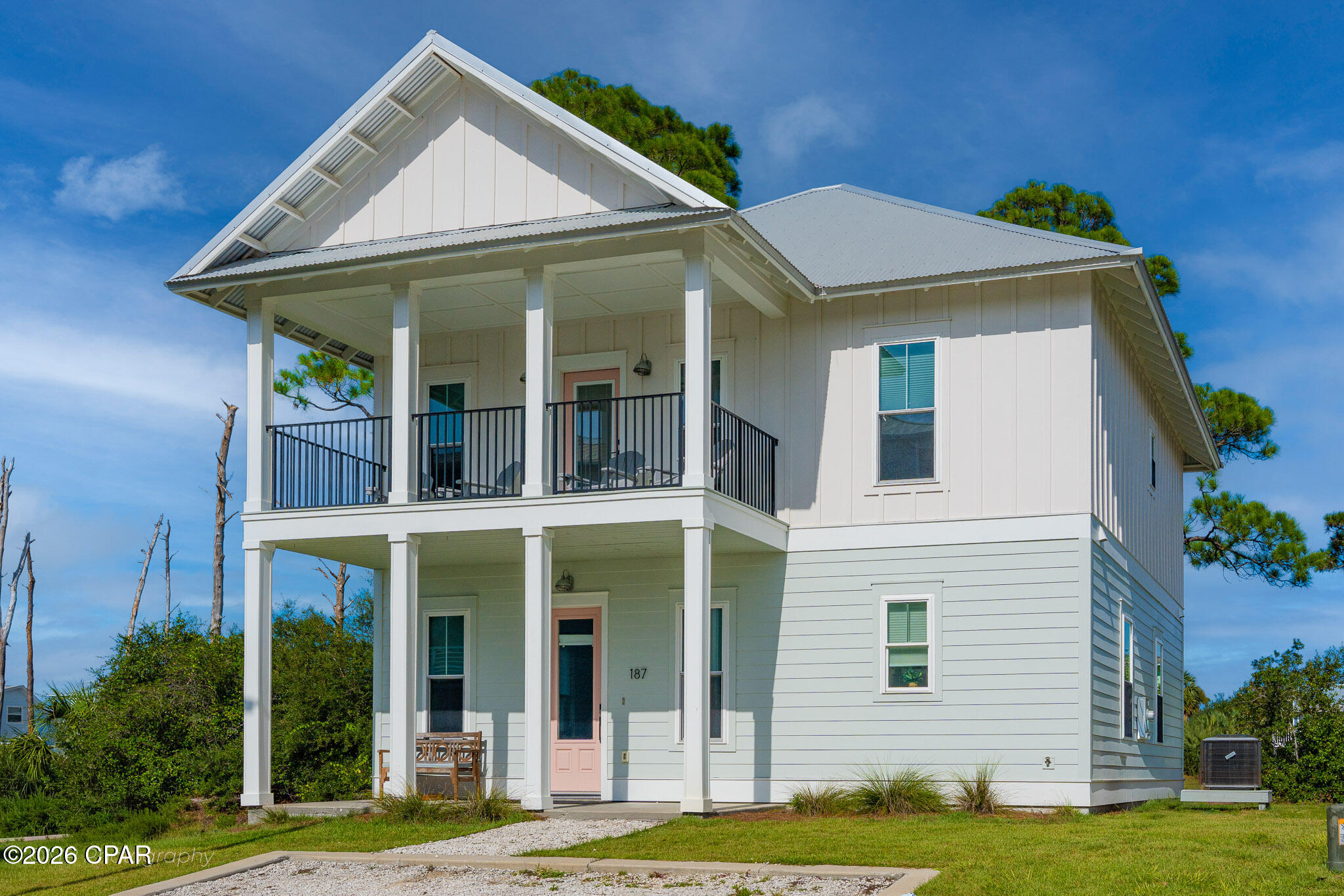 Just steps from the sugar white sands of Cape San Blas, 187 Tortuga Trail offers a rare combination of new construction quality and an unbeatable location. Built in 2023 by Ben Wortman Construction, this thoughtfully designed home showcases classic coastal cottage architecture, with double stacked covered porches and standing seam metal roofing setting the tone from the curb. Inside, approximately 1,998 square feet unfold across four bedrooms and three full and a half bathrooms, with two separate living rooms on the main and second floors that give family and guests room to spread out after a day at the beach. The main level offers an open concept living, dining and kitchen layout finished with quartz countertops and stainless steel appliances, while the primary suite features a vaulted ceiling and a spa style bathroom with a freestanding soaking tub and frameless glass shower. The home is being sold fully furnished and turnkey ready, with no homeowners association. The home resides in Flood Zone X, so flood insurance is not a lender requirement, making ownership as simple as it is rewarding.
Beach access is just steps away, and the coastal lifestyle extends well beyond the shoreline. A short walk or bike ride brings you to Salinas Park, where bay access, boardwalks, picnic pavilions, a playground and pickleball courts create an easy gathering spot for neighbors and visitors alike. Just to the north, St. Joseph Peninsula State Park protects miles of undeveloped dunes and pine flatwoods, with hiking trails, prime birdwatching and some of the most pristine beaches on the Gulf Coast, regularly ranked among the best in the country.
Whether used as a primary residence, second home or investment property, 187 Tortuga Trail delivers the character, craftsmanship and coastal setting that define life on Cape San Blas. You deserve to see this home in person today!