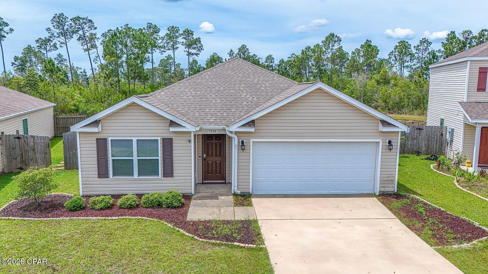 This adorable 4 bed, 2 full bath, Craftsman style home is located in the quiet Barrett's Park Neighborhood off Highway 231.  The location offers convenience near Publix, Starbucks, and minutes away from Panama City, and white beaches of Panama City Beach. and Tyndall A.F.B.  Entering the home, you still feel the like new construction atmosphere, and  greeted by wide hallways and inviting open floor plan concept which is ideal for everyday living and entertainment. LVP throughout and like new carpets in the bedrooms.  The kitchen features a spacious island, abundance of cabinetry and pantry.  Stainless steel appliances and breakfast bar overlooking the ample living room.  You have a dining area away from the living room for your formal dining. The living room has numerous windows overlooking the tranquil pond, thus bringing in natural lighting inside the home.  Split bedrooms with the large master having a tub and shower.  Large master closet in the bathroom area. Stepping outside you have a full fenced in area and a retention pond in your back yard, perfect for relaxation and a morning cup of coffee.