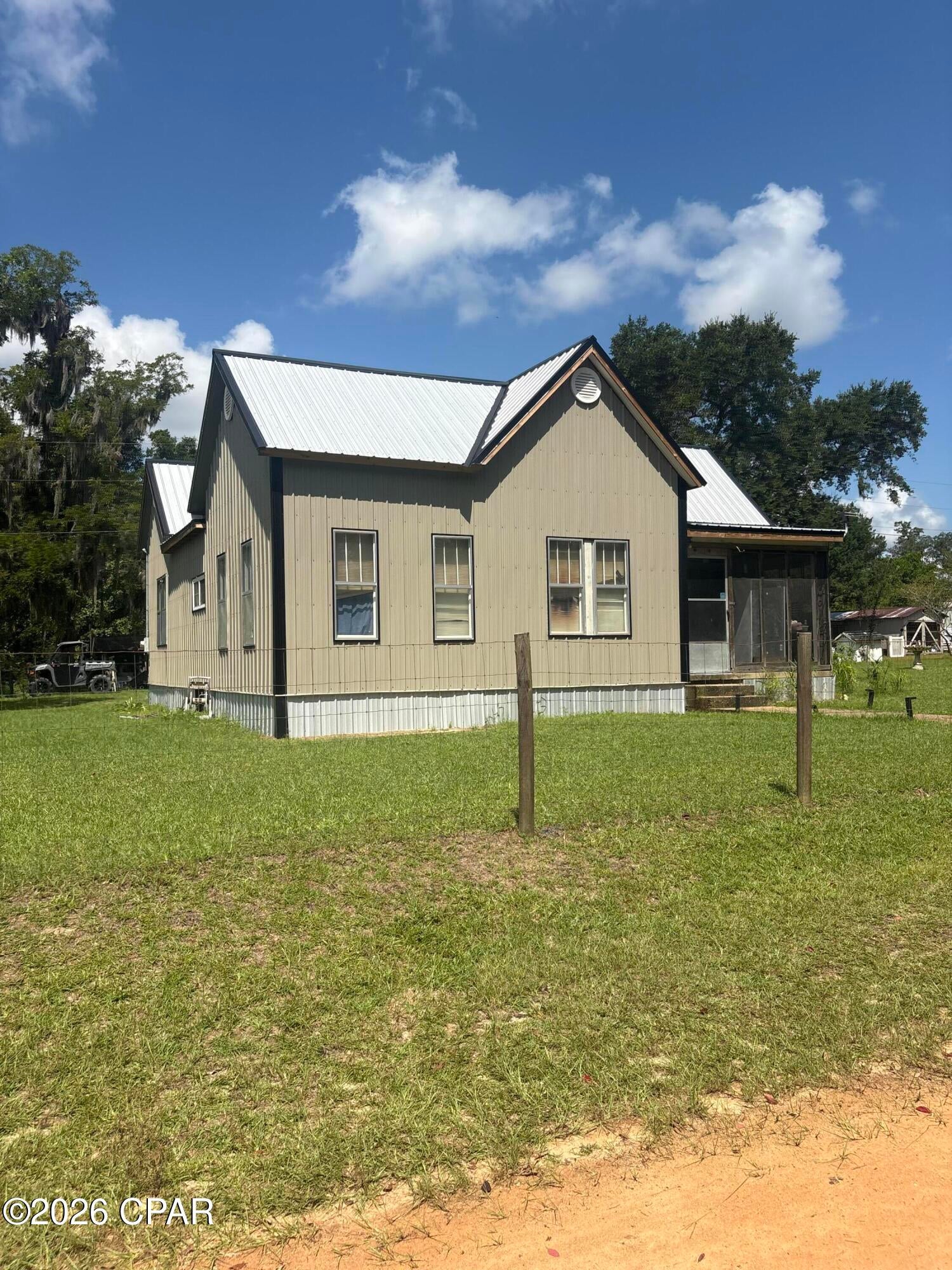 Discover the charming character and potential of this inviting country home in Alford, Florida. Featuring a new metal roof, durable metal siding, spacious yard with endless possibilities, located near by Round Lake, a beautiful Lake where you can enjoy outdoor actives soaking up the sun. This property offers a peaceful rural setting with plenty of room to make it your own. Inside, you'll find warm wood accents, traditional layout, and plenty of opportunity to personalize and update. A great opportunity for buyers looking for space, privacy, and the charm of historical Jackson county!