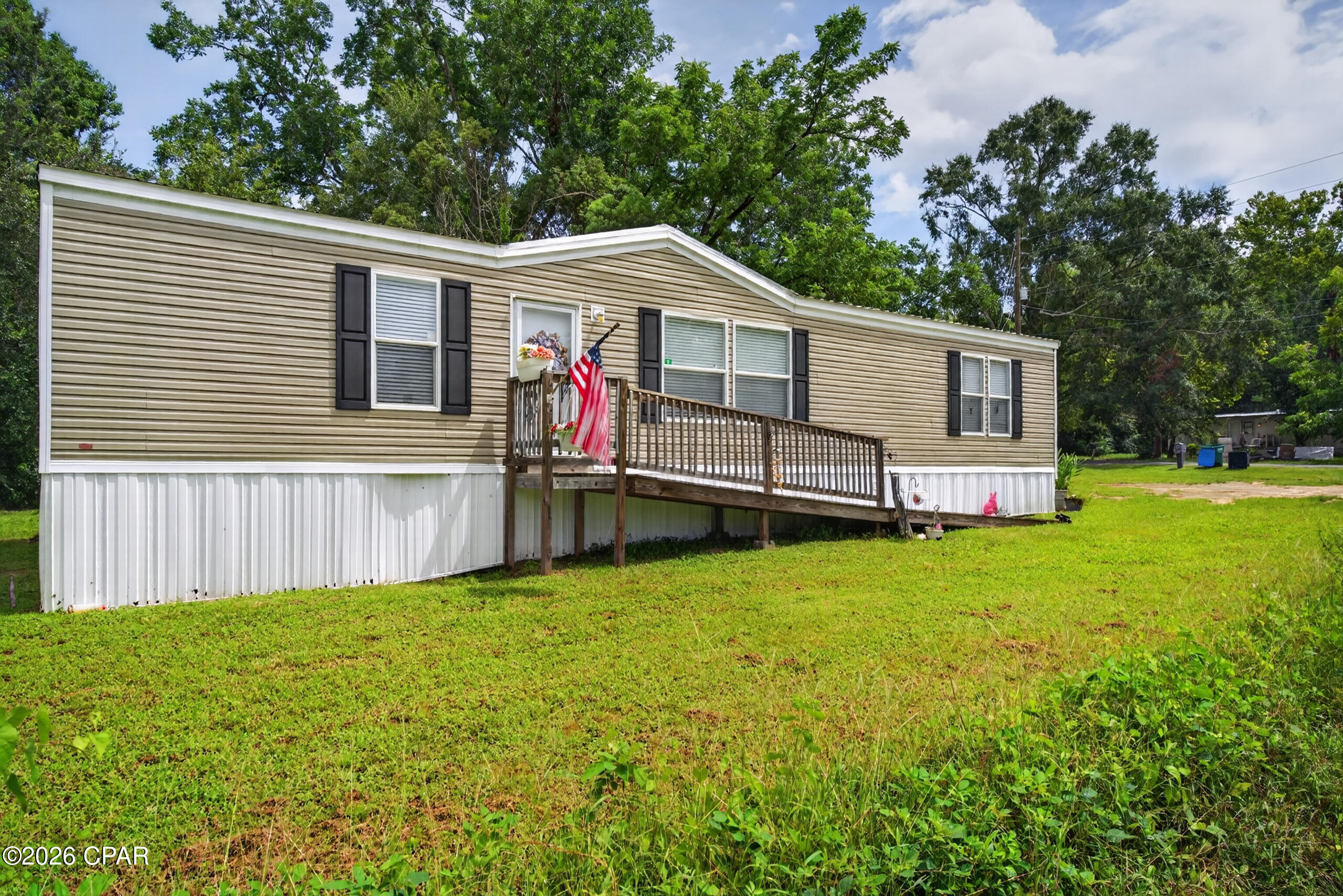 Welcome home to this well-maintained 2023 double-wide mobile home located in Bonifay on a paved road. The inviting open-concept floor plan features a spacious living area that flows seamlessly into the kitchen, complete with a center island, stainless steel appliances, and a dedicated coffee bar. Offering three bedrooms and two bathrooms, the split-bedroom design provides added privacy. The primary suite includes a spacious bathroom with a double vanity, soaking tub, and generously sized closet. A nice-sized laundry room adds extra convenience, while the fenced backyard provides a great space for pets or outdoor entertaining.
