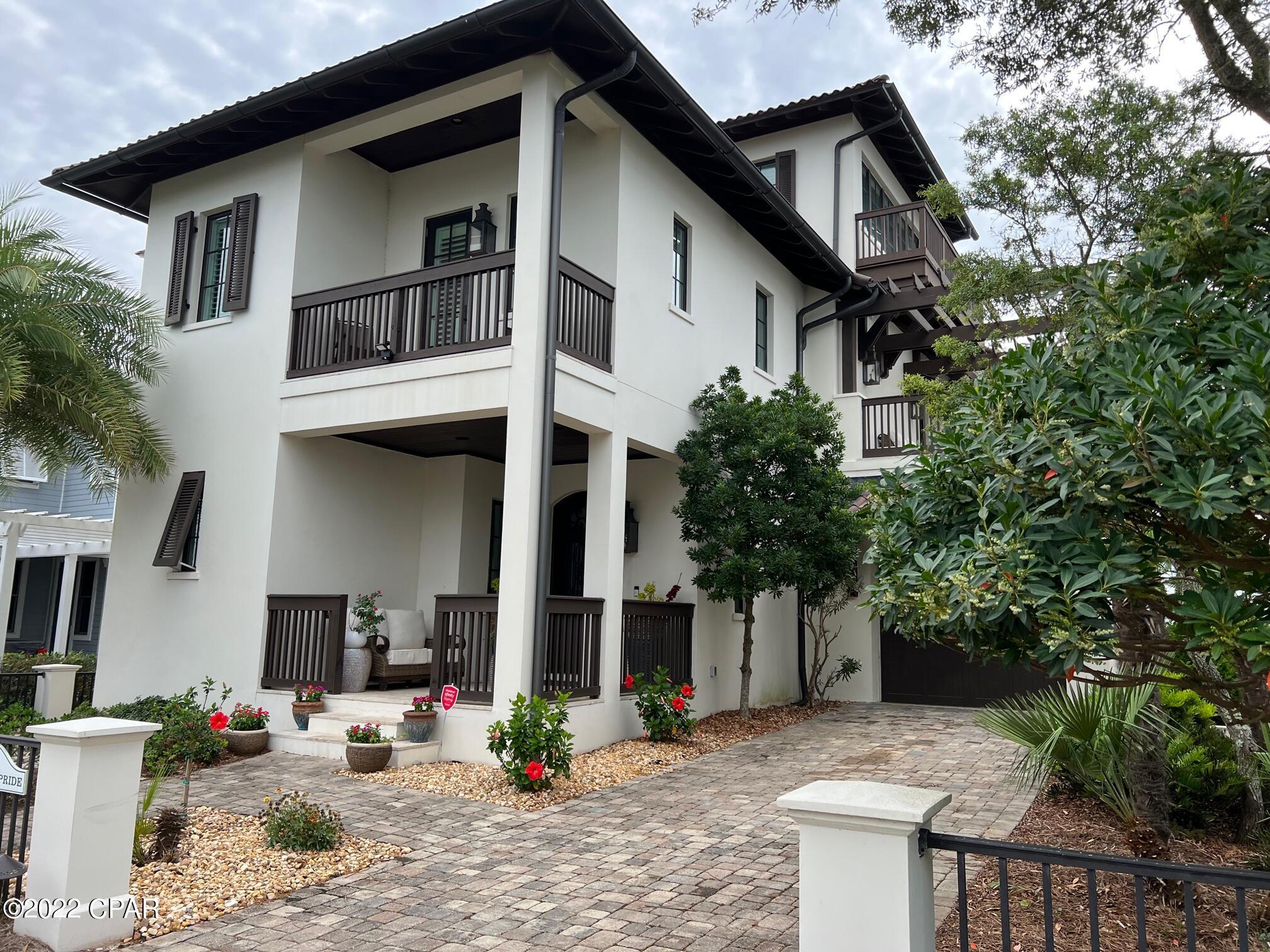 This extraordinary custom home in the gated community of Carillon Beach is located on beautiful Lake Carillon and enjoys Gulf of Mexico views from the tower on the third floor. There are too many custom features in this home to even mention from the wide plank white washed floors to the lighted quartzite countertops in every bathroom and kitchen to the handmade shell chandeliers and the gas lanterns, it is simply amazing. There are 4 bedrooms, 4-1/2 baths, an elevator, summer kitchen, outdoor alfresco dining area, garage, lakefront beach area, bonus sitting areas in the master bedroom and on the second floor. Also on one of the second floor porches, there is an outdoor gas fireplace. The construction is concrete block and the roof is clay. EASY SHOW.