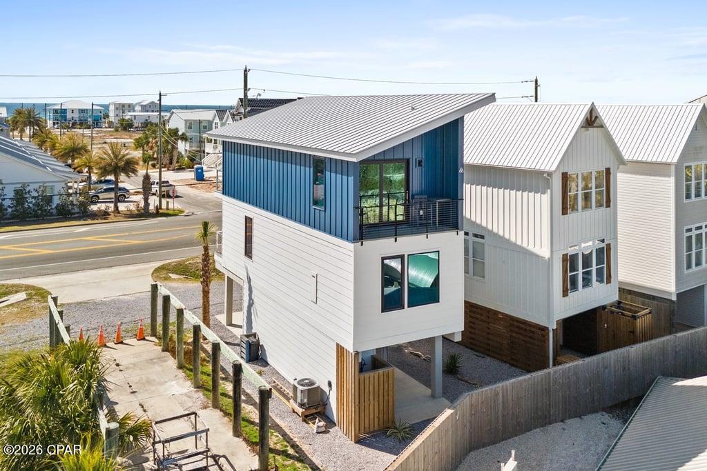 Welcome to 4106 Hwy 98, the most affordable detached single-family canal-front home currently on the market in Mexico Beach. Built in 2023 by Crest Enterprises, this 2BR/2.5BA contemporary beach house offers 1,264 square feet of living space across two stories with gulf views and direct canal access right out your back door. For the boater, this property comes with your own private boat slip with water and electricity, accommodating vessels up to 30 feet, meaning you can be on the water in minutes rather than driving to a marina. You do have the ability to add a lift if desired. The interior features an open-concept layout with vaulted ceilings, engineered flooring, a top-notch kitchen with a breakfast bar, and high-end furniture throughout. The primary suite offers panoramic views of the Gulf and a tiled walk-in shower, while the bunk nook gives you flexibility for your younger guests. Step outside onto the rear porch, and you are overlooking the canal and your own dock, the perfect place to rig up before an early morning run offshore. The beach is a three-minute walk away! Opportunities to own a canal-front home at this price point in Mexico Beach are becoming increasingly rare. Call today!