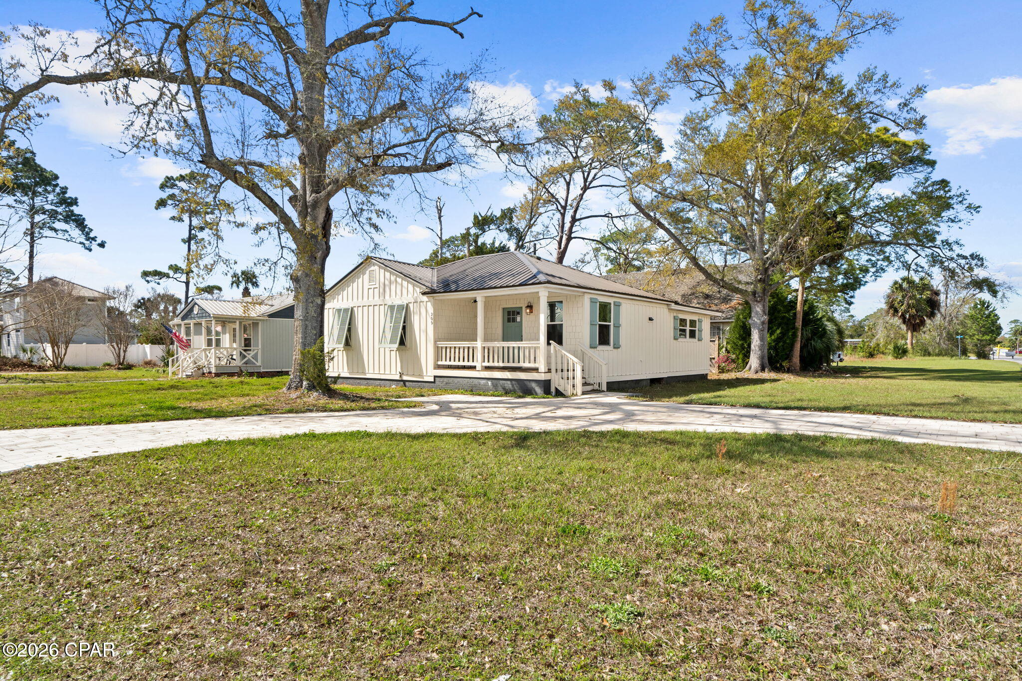 COASTAL COTTAGE DREAM NEAR THE BAY!! This fully renovated 3 bedroom/3 bath coastal cottage sits on a beautiful corner lot just two blocks from the water, where you can even catch a glimpse of the bay from the street. If you've been dreaming of an easygoing beach town lifestyle with everything close by, this charming home delivers. Step inside & you're welcomed by a cozy dining area that flows into a beautifully updated kitchen featuring crisp white cabinetry, stylish plumbing fixtures, modern finishes & a convenient breakfast bar that opens directly into the spacious living room. The layout creates an inviting open feel that's perfect for relaxing after a day on the water or entertaining friends & family. The home offers a comfortable split-bedroom floor plan. Luxury vinyl plank flooring runs throughout the home, offering durability & easy coastal living. The bathrooms have been tastefully updated, including tile flooring & tiled shower finishes that give the space a fresh, modern feel. Outside, the property continues to impress with a beautiful circular paver driveway, making it easy to pull in, pull through or park multiple vehicles & golf carts. The home also features charming curb appeal that perfectly fits the relaxed coastal character of the neighborhood. The location is truly one of the highlights. Just two blocks from the bay, you're moments from launching a kayak, paddleboarding on the calm waters of St. Joseph Bay, or enjoying peaceful waterfront sunsets. Even better, you can hop on your golf cart & cruise into downtown Port St. Joe for boutique shopping, live music, local restaurants & all the fun things this vibrant coastal town has to offer. Whether you're looking for a weekend getaway, full-time residence, or investment opportunity, this adorable cottage near the water offers the perfect blend of location, charm & coastal lifestyle. Call for your private tour & LIVE THE BEACH LIFE!
