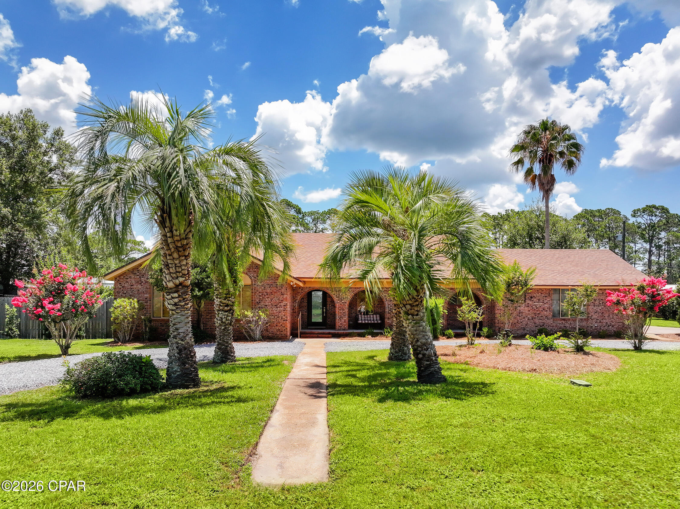 Priced Under Market Value... This charming brick home in the heart of Port St. Joe, where beautiful views of St. Joseph Bay and the relaxed coastal lifestyle come together. This well-maintained home features 3 bedrooms and 3 full bathrooms, offering plenty of space for family and guests. The beautifully renovated kitchen showcases quartz countertops, stainless steel appliances, and ample cabinetry, flowing seamlessly into the spacious living area anchored by a double-sided gas fireplace and bar area with wine refrigerator. A bright Florida sunroom just off the dining area provides the perfect place to enjoy your morning coffee. The spacious primary suite offers a private retreat with an ensuite bathroom. Outside, you'll find an expansive yard with room to add the pool of your dreams, along with abundant storage including a workshop, yard building, and an attached two-car garage. Situated on two lots with approximately 200 feet of road frontage, this property also offers incredible potential. Located just minutes from downtown Port St. Joe, you can hop on your golf cart and enjoy local restaurants, boutique shopping, live music, and community events. End each day watching spectacular sunsets over St. Joseph Bay. Whether you're searching for a primary residence, second home getaway, or investment opportunity, this property offers the perfect blend of space, location, and coastal charm.