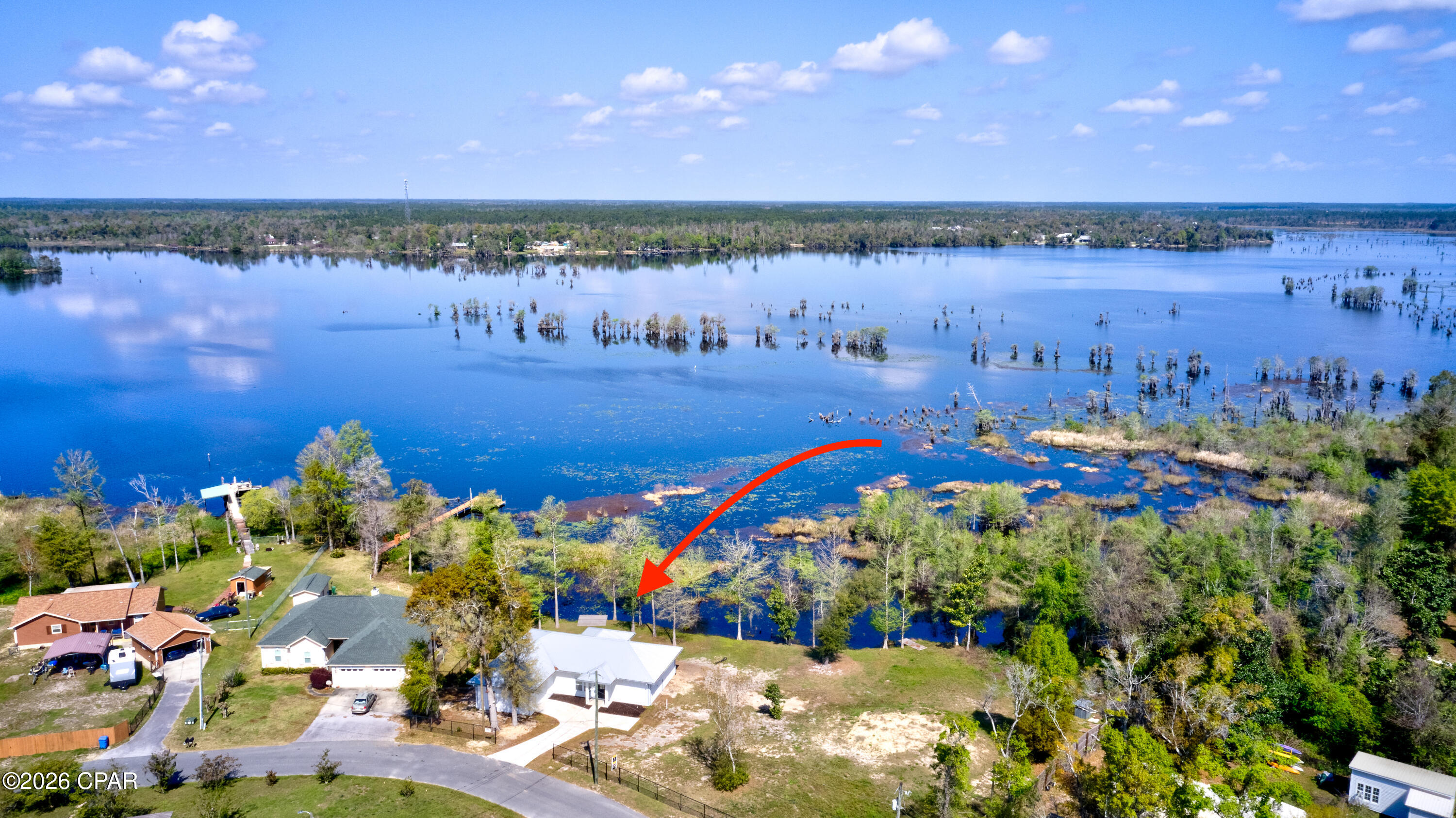 Brand-New West-Facing Lakefront Home on Deer Point Lake! Discover the perfect blend of modern comfort, outdoor adventure, and breathtaking natural beauty with this new construction home on Deer Point Lake. West-facing and perfectly positioned to capture incredible sunsets over the water, this home features an open-concept main living area with breathtaking lake views from almost every room. The spacious layout includes 2 bedrooms, each with its own private bathroom, plus a versatile bonus room that can easily serve as a guest room, kids' bunk room, home office, or additional flex space. In addition, there is also a large third bathroom with a convenient indoor laundry area. The heart of the home is the gourmet kitchen, featuring a large center island, premium granite countertops, abundant cabinetry, a spacious pantry, and a deep-basin farmhouse-style sink. Whether you're preparing a quiet dinner at home or entertaining friends and family, this kitchen is designed to be both beautiful and functional. Step outside to the covered lakefront patio, where you can relax, entertain, watch the sunset, or simply enjoy the peaceful views. The spacious lot is partially fenced and offers plenty of room to enjoy the outdoors. An attached garage, long driveway, and two additional parking pads provide ample parking for vehicles, boats, and guests. Additional construction upgrades include the use of hardie board siding, a durable metal roof complete with gutters, on-demand hot water plus the home was constructed 3 feet above the flood zone for added peace of mind. The location offers both privacy and convenience, with Garner's Supermarket & Deli and a DG Market nearby, two public boat ramps less than a mile away, and a short drive to the new Publix shopping center on Highway 231, Ascension Sacred Heart, and Tyndall Air Force Base. Deer Point Lake offers outstanding opportunities for freshwater fishing, kayaking, jet skiing, boating, and other water activities, all right in your backyard. And there's even more value: the seller is offering $3,500 in concessions, which can be used toward eligible closing costs, new kitchen appliances, landscaping, or other buyer expenses. Don't miss this rare chance to own a brand-new lakefront home with private water access, incredible sunsets, and the best of Deer Point Lake right outside your door. Schedule your private showing today!!!