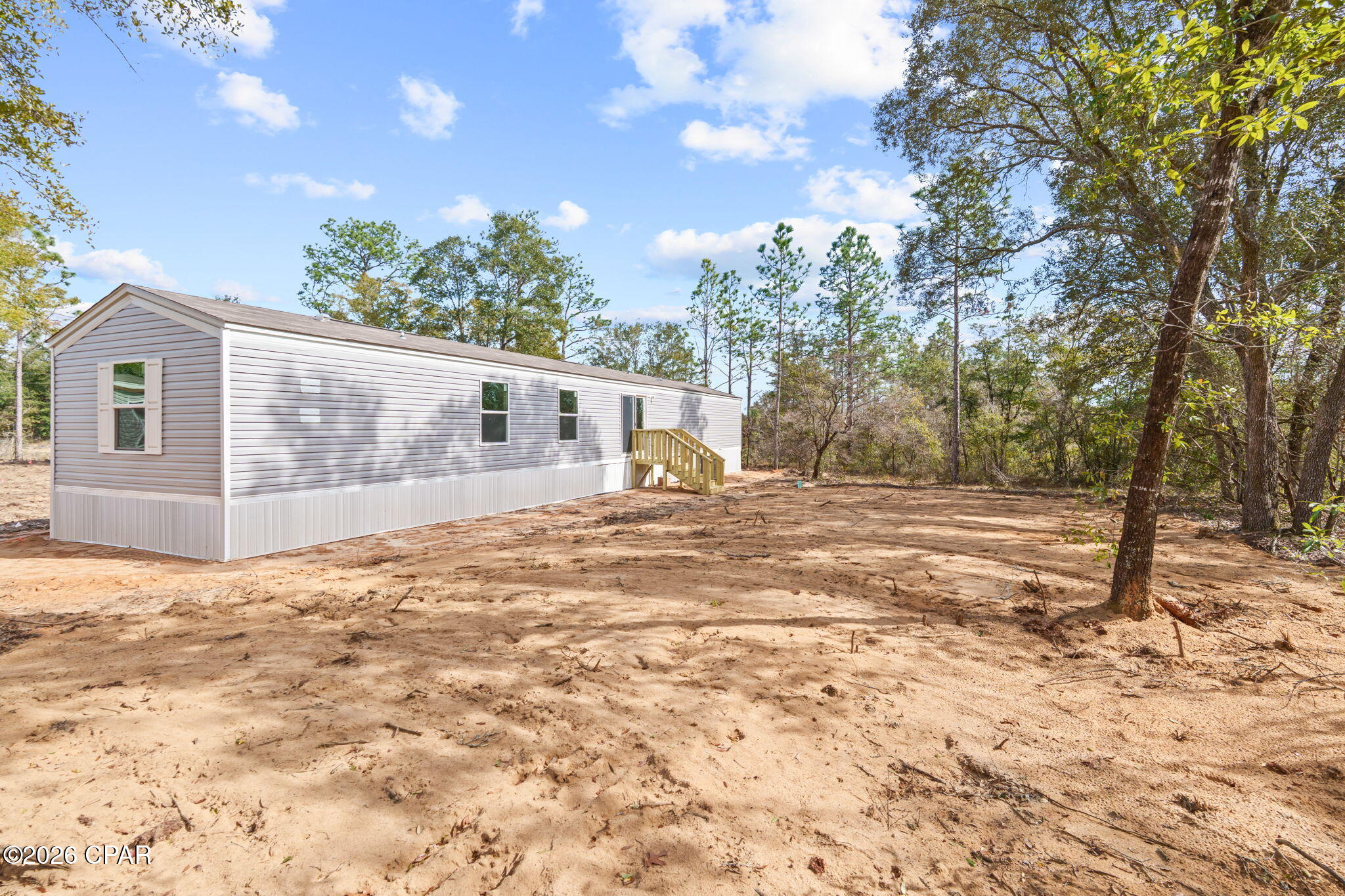 Welcome to this BRAND NEW 2026 Model, 3 bedroom/2 bath, single-wide manufactured home featuring cozy interior and exterior colors and a thoughtful layout. This home is apart of the Paradise Lakes Community, so you'll have access to the lakes, boat ramp, clubhouse, & everything else Paradise Lakes has to offer! The open floorplan creates a bright, welcoming living space, complemented by a versatile flex/bonus room ideal for a home office, playroom, or extra living area. The kitchen offers black appliances, ample cabinetry, and an island perfect for everyday living. The spacious primary suite includes a luxurious bathroom with a soaker tub and huge separate stand-up shower! The primary bath is also home to a large walk-in closet for all your storage needs. This new home sits on half an acre just waiting for you to add your personal touches after you call this place HOME! The front and backyard is level and clear directly around the home making it the perfect canvas for your outdoor storage needs. Location is key and this house is located about 2.5 miles (7 minutes) from Hwy 77. You'll have the ''country'' feel without being too far from all the attractions that Chipley, Lynn Haven, and Panama City have to offer! Come check it out!