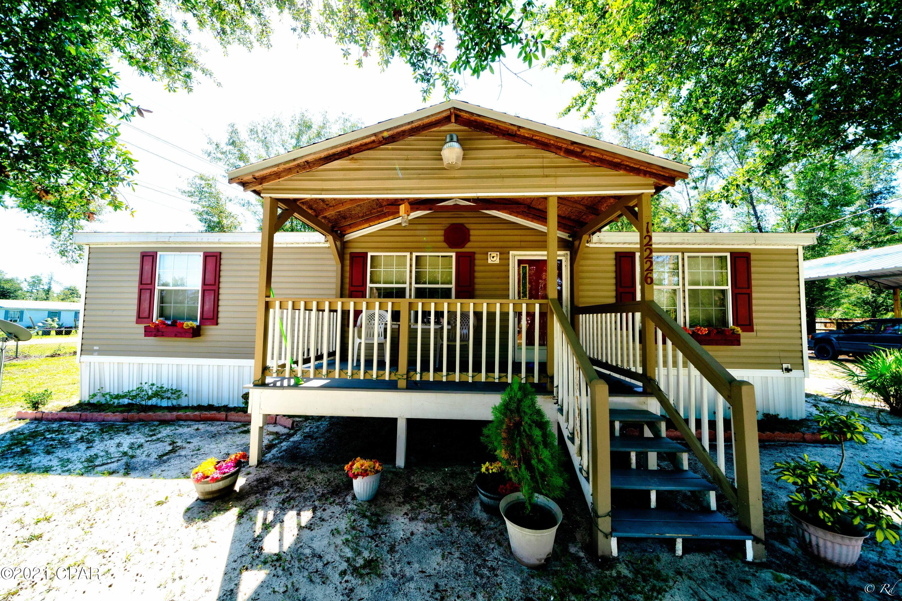 ''Under the Oaks''!! BEAUTIFUL, PEACEFUL over a half acre of quiet serentity!! Freshly painted, NEW 24x24 open span POLE BARN, Security cameras with monitor, roof 2019, completly fenced, corner lot home is waiting for you!! Seller bought the 2 neighboring lots, has cleared them, put in a fire pit...... all for your outdoor enjoyment!! There is a 10x12 shed, wired with a 20 amp breaker. Dusk till dawn lighting on the porch and shed. AC 2016. Engineered, permited  Pole barn was built to last - with steel pulins and extended front overhang!! The eaves are 10'6''!!! This is an amazing opportunity to live in the country for under 150k!! Call your favorite Realtor to see this one...you will be glad you did! Surveys have been done! County maintains the road!!! Buyer to confirm measurements