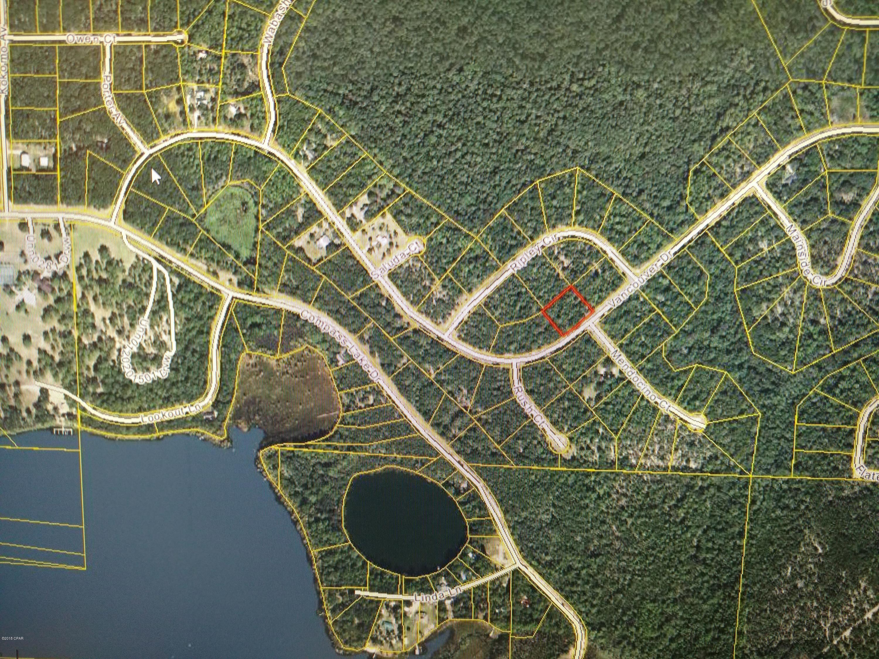 QUICK SALE PRICE REDUCTION! in the Beautiful Compass Lake in the Hills Subdivision.  This home building lot is on the paved Vancouver Dr., immediately north of the Main Club House, Restaurant, Tennis Courts, Swimming Pool, Horse Riding Stables, Campgrounds, and Boat Launch Facilities on the Main Compass Lake. As a landowner in this beautiful 10,000 acre subdivision, you will have a lot of privileges that only huge property owners can enjoy, such as your own private access to two huge freshwater lakes and a several smaller ones!  Miles and miles of roads and trails to enjoy walking or driving on. You can even camp in the nice rental cabins overlooking Compass Lake for a Leisurely Vacation each year, while waiting to build your retirement home in the future. OWNER FINANCING AVAILABLE
