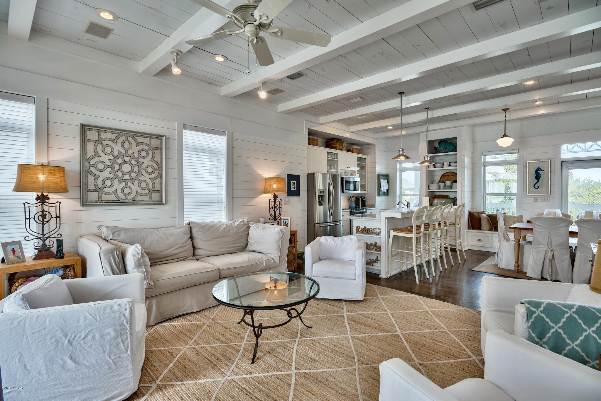 A true gem presents itself at 70 South Ryan Street along spectacular Scenic Highway 30-A in Santa Rosa Beach, Florida. This coastal beach retreat in the Seagrove area is sure to impress with stunning views and convenient beach access just a few feet from the home. Rental income potential over $100,000 per year gross has been projected by multiple local rental companies.  The 4 bedroom, 3 full bathrooms and one half bath design couples coastal contemporary elegance with classic Florida beach cottage overlooking one of the more private beach settings along 30-A. Summer's Edge is a popular vacation rental community but this home hasn't been rented and is in great condition. Summer's Edge offers two pools, one which is steps from the home.  Three bedrooms including one master suite are situated on the 1st floor while the main living areas of this home are on the 2nd floor and boast tremendous views over a deep, covered balcony setting. Shiplap is prevalent throughout the home and is tied together with other exemplary construction accents like exposed beams.  The 2nd floor also offers a second master suite with access to the balcony and accompanied by a full bathroom with separate tub & shower with double vanity.