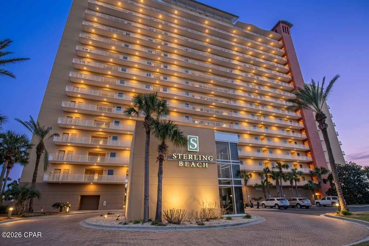 3BR/3BA Gulf-front condo at Sterling Beach in Panama City Beach. 34 feet of floor-to-ceiling glass, 12-foot ceilings and covered parking #15. From the moment you arrive at Sterling Beach, the winding paver drive, Royal Palms and Gulf-front setting create a memorable introduction. Unit 1401 is a 2,274-square-foot Gulf-front condominium where approximately 34 feet of floor-to-ceiling glass showcases expansive Gulf and coastline views. Large rooms, abundant natural light and oversized crown molding complement the spacious interior.  The completely upgraded kitchen gives this residence a distinctive look of its own, with new cabinetry, backsplash, tile flooring, laundry room cabinetry and black stainless steel appliances. The centerpiece is the Vetrazzo countertop surface, where colorful recycled-glass pieces create an artisanal, mosaic-like appearance reminiscent of sea glass and the emerald-toned Gulf beyond the windows. An oversized open enamel sink completes the updated kitchen.  Updates continue throughout the baths with new granite countertops and tile flooring. The primary suite offers a large walk-in closet, private balcony and bath with double vanities, walk-in shower, jetted tub and private water closet. The second primary bedroom serves as the lockout suite and features its own private balcony and a completely remodeled bath with a custom tiled walk-in shower with bench, vessel sinks and a beautiful handcrafted barn door. Tile flooring also enhances both the main entry and separate lockout entry.  One of Unit 1401's most versatile features is this second primary suite and lockout configuration. With the addition of an interior door in the foyer area, the residence can function as a full 3-bedroom condominium or allow the second primary suite to be separated, providing flexibility for personal use or rentals. Short-term rentals are allowed. The residence was also wired for surround sound during construction, and water heaters were replaced in 2021 and 2023.  Unit 1401 includes covered garage parking space #15. Sterling Beach offers approximately 400 feet of Gulf frontage along with a heated free-form pool and expansive deck areas, spa/hot tub, Gulf-front fitness center, high-speed elevators, bike and kayak racks, owners lounge and meeting room, 44-seat theater, BBQ and picnic area, covered pergola and beach access. Onsite HOA and rental offices provide additional convenience.  Located on Thomas Drive in Panama City Beach, Sterling Beach provides convenient access to restaurants, grocery shopping, marinas, fishing, diving and sightseeing operations, with St. Andrews State Park toward the east end of Thomas Drive. Built in 2003, Unit 1401 combines panoramic Gulf views, extensive interior upgrades, a second primary lockout suite, covered parking and resort-style amenities. Monthly HOA dues are currently listed at $1,191.98. Schedule a showing to experience the space, finishes and Gulf-front setting of Sterling Beach Unit 1401.