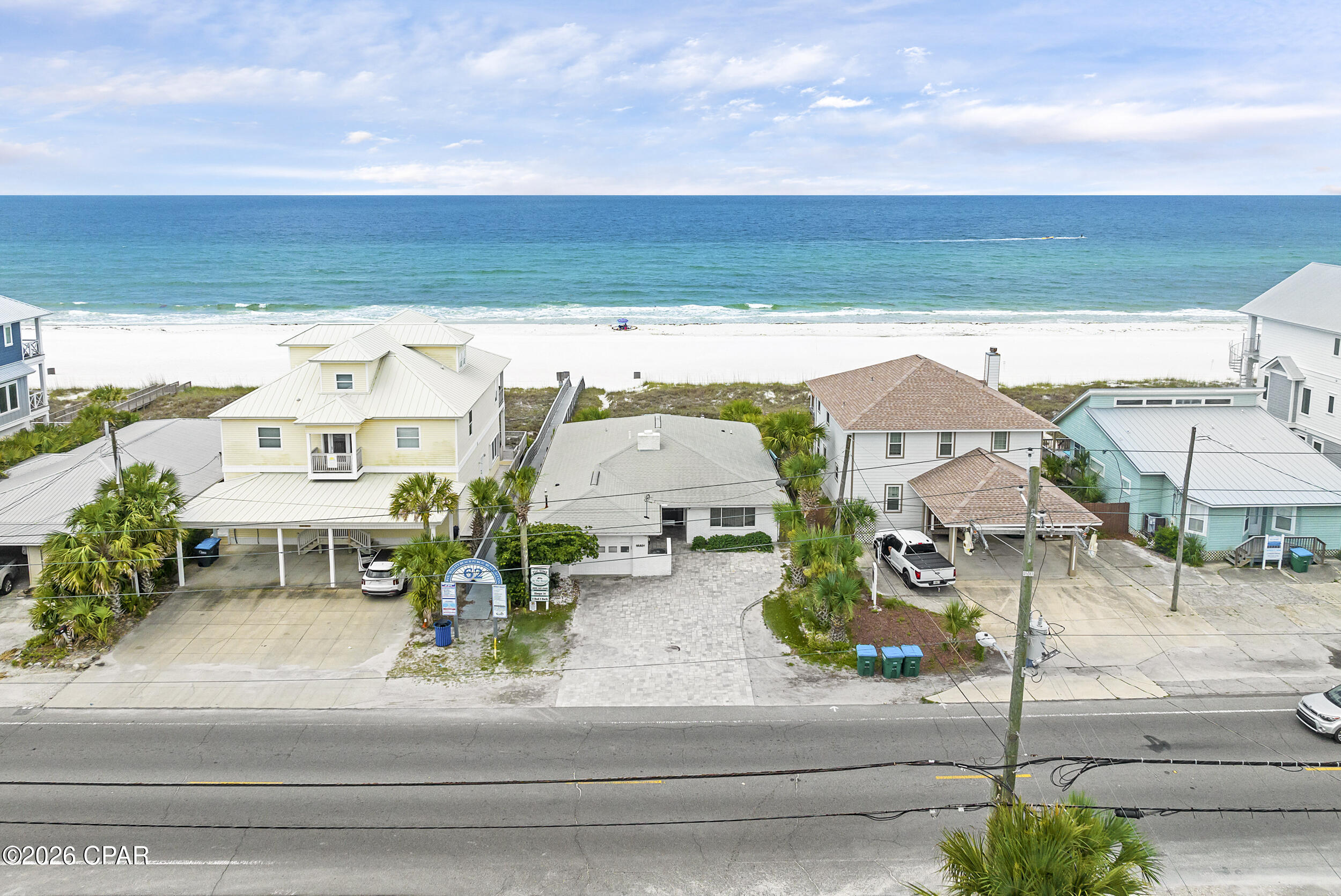 This all-brick, gulf-front home sits on 50 feet of open beach frontage in the heart of Panama City Beach, steps from Pier Park and directly on the sand. No high-rise above it and no HOA. Just direct beachfront access and uninterrupted gulf frontage.

The 1,200 sq ft deck spans the full width of the home - nearly all of it just updated - built around what actually matters here: the view, the breeze, and the kind of Florida weather that keeps you outside most of the year. Mornings start with coffee and soft light over the water. Afternoons settle into open space and steady salt air. Evenings stretch into wide, unobstructed sunsets that run clean across the horizon.

Inside, a full wall of newly installed, impact-rated hurricane glass opens the main living area to constant water views while delivering the kind of storm protection that matters on the Gulf. Tile floors throughout keep things low-maintenance after time on the sand. A white brick fireplace handles the cooler months. 

Five bedrooms and three bathrooms allow the home to comfortably accommodate extended stays, larger groups, or consistent vacation rental use. The gulf-front primary suite opens directly onto the deck. The property is currently operating as a successful short-term rental.

A brick-paved driveway provides parking for three vehicles.

Brick construction is a rarity on the Gulf. What was built to last has lasted - and in a market where gulf-front lots are essentially gone, the land itself carries weight. Direct beach frontage at this location, no HOA, no deed restrictions - the kind of position that's worth holding regardless of what sits on it. Whether the play is enjoy it now, rent it, or eventually redevelop, the optionality here is real. 

Schedule your private showing.