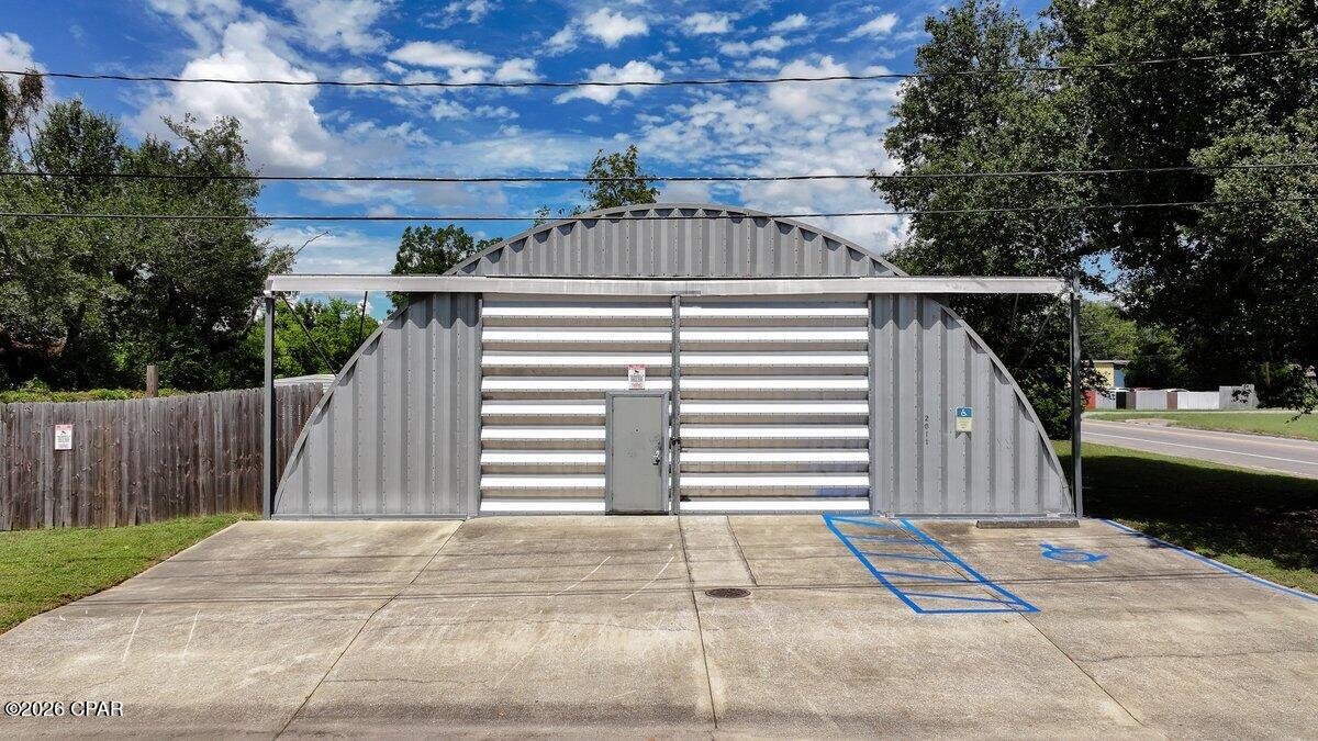 Minutes from the Panama City waterfront, this turnkey 5,000± SF climate-controlled facility delivers industrial-grade power and ultimate flexibility for your growing business or portfolio. Quonset steel build with high-efficiency spray foam insulation (walls and roof). Equipped with 3-phase power and 20 ft height, perfect for boating, automotive, fabrication, woodworking, or commercial warehouse operations. Epoxy-coated concrete floors, upgraded LED lighting throughout, and a 14' front sliding door for seamless vehicle and equipment access. Includes a dedicated office, kitchen and extra storage room, with a concrete slab foundation suitable for commercial loads. An auxiliary 12' x 40' portable building is available for separate purchase if extra square footage is needed. Minimum 5 dedicated outside parking spaces on site. Adjacent land lot is available for potential separate purchase if additional parking or yard storage is needed. Less than a mile from Watson Bayou and the Millville boat launch, this is an ideal commercial business opportunity. Whether you need a marine-centric workshop, a high-clearance equipment facility, or a clean, climate-controlled warehouse in Panama City, this adaptable property is move-in ready