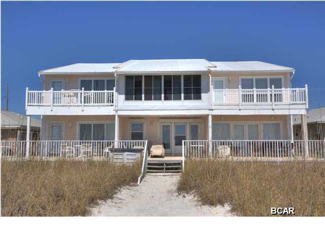 If you are looking for your beach house or a great investment this is for you! Over 1800 sq ft, 3 bedroom, 3 bath well maintained townhouse right on the Gulf of Mexico! This townhouse is the far west unit of a small 3 unit complex in the quiet west end area of Laguna Beach. You can not beat the location being 4 miles either way to Pier Park or Rosemary Beach. As you are welcomed into the bottom floor, through the entry, you will have a downstairs bedroom and bathroom. An open living room, kitchen and dining combo are accompanied by a wall of windows overlooking the incredible view. The kitchen is completely remodeled with upgraded off white cabinetry, granite countertops and stainless stove/oven, dishwasher and microwave. Upstairs you have two oversized bedrooms with their own