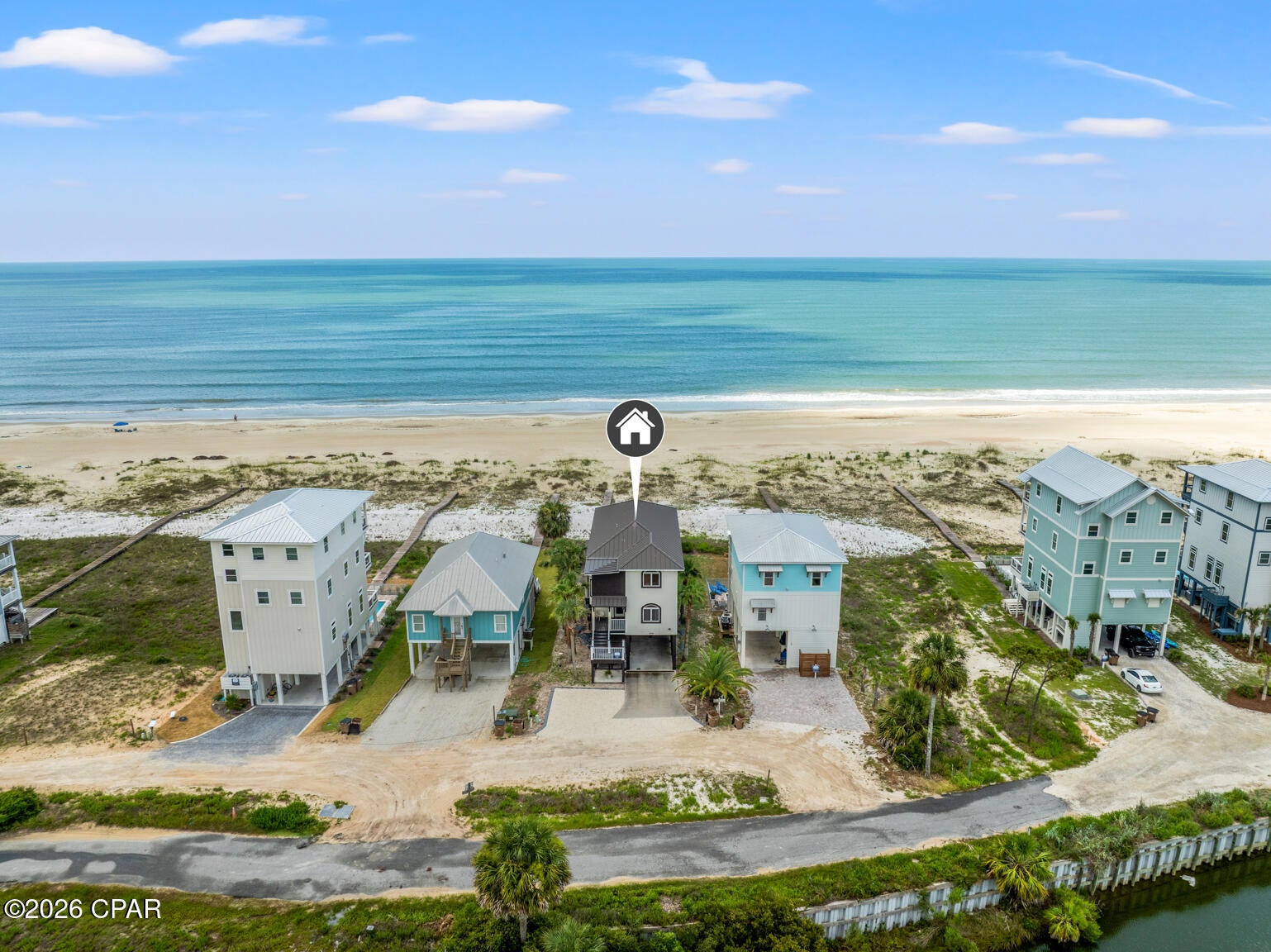 Live the dream on the Gulf in this stunning 4-bedroom, 3-bath beachfront residence offering direct Gulf access and breathtaking views. Thoughtfully designed for comfort and entertaining, this 2,432 sq ft home blends refined finishes with relaxed coastal living. The open-concept layout centers around a gourmet kitchen featuring a large island with prep sink, 6-burner Thermador gas range, stainless appliances, and custom cabinetry. Expansive windows in the great room frame panoramic Gulf views, while a fireplace adds warmth and ambiance for those rare cool evenings. The tranquil primary suite features a wood-accented ceiling, walk-in closet, and private access to a screened porch overlooking the beach. Three additional bedrooms provide ample space for guests or family. On the beach level, coastal living shines with an outdoor kitchen, farmhouse sink, bar seating, dining area, fire pit, and six-person hot tub--all steps from your private boardwalk to the sand and water. Enjoy morning coffee or evening sunsets with unobstructed views across the Gulf. Located minutes from downtown Port St. Joe dining, boutiques, and marinas, this property offers easy access to local favorites like Indian Pass Raw Bar and nearby boat launches for fishing or scalloping adventures. Whether you're seeking a full-time residence or a luxury vacation investment, this Gulf-front retreat delivers coastal living at its best. Schedule your private tour today.
