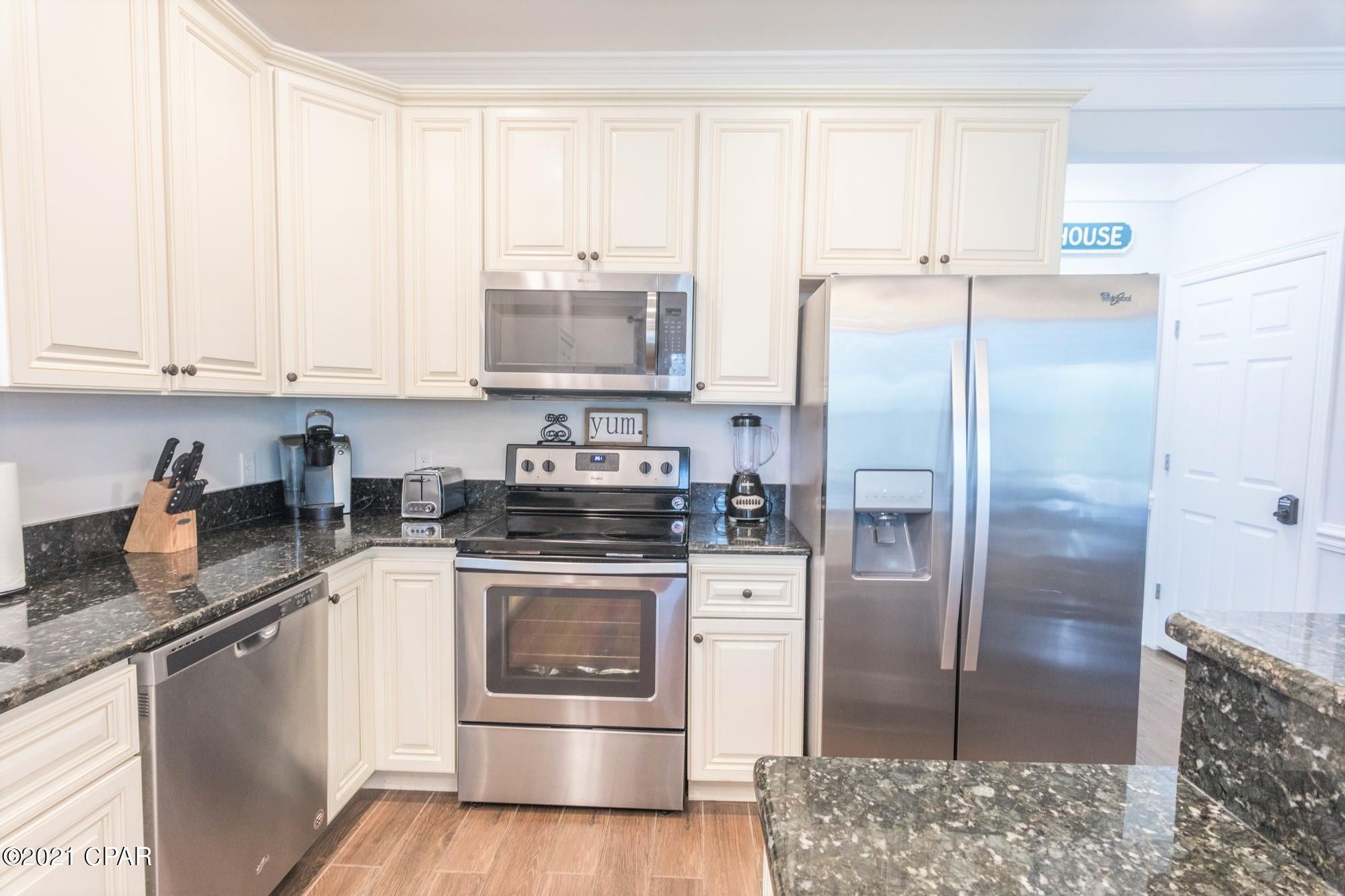 5 STAR REVIEWS and POTENTIAL RENTAL INCOME of $85,000! ! This beautiful beach home is just a short walk to the beach and only 2 blocks to South Lagoon. This is a great investment property or perfectly suited as a full-time residence or second home. Built in 2017, this home offers 3 bedrooms plus a bonus (bunk-room) with 2.5 Baths and a 2 car garage. Additional features include porcelain wood tile on main level, wide plank hardwoods throughout second floor, granite counter tops, sizeable walk-in closets, and floor to ceiling tiled showers. The fully equipped kitchen offers stainless steel appliances, bar height island, white cabinetry and plenty of natural light. The large rear porch provides ample room to enjoy the warm Gulf breeze. The spacious backyard is fully fenced with an irrigation system.  This convenient location is a brief walk, bike ride or golf-cart ride to the beach, shops and restaurants. Home is offered FULLY FURNISHED and the GOLF CART IS INCLUDED!  (Seller to provide a $3000 credit towards re-sodding the yard.)