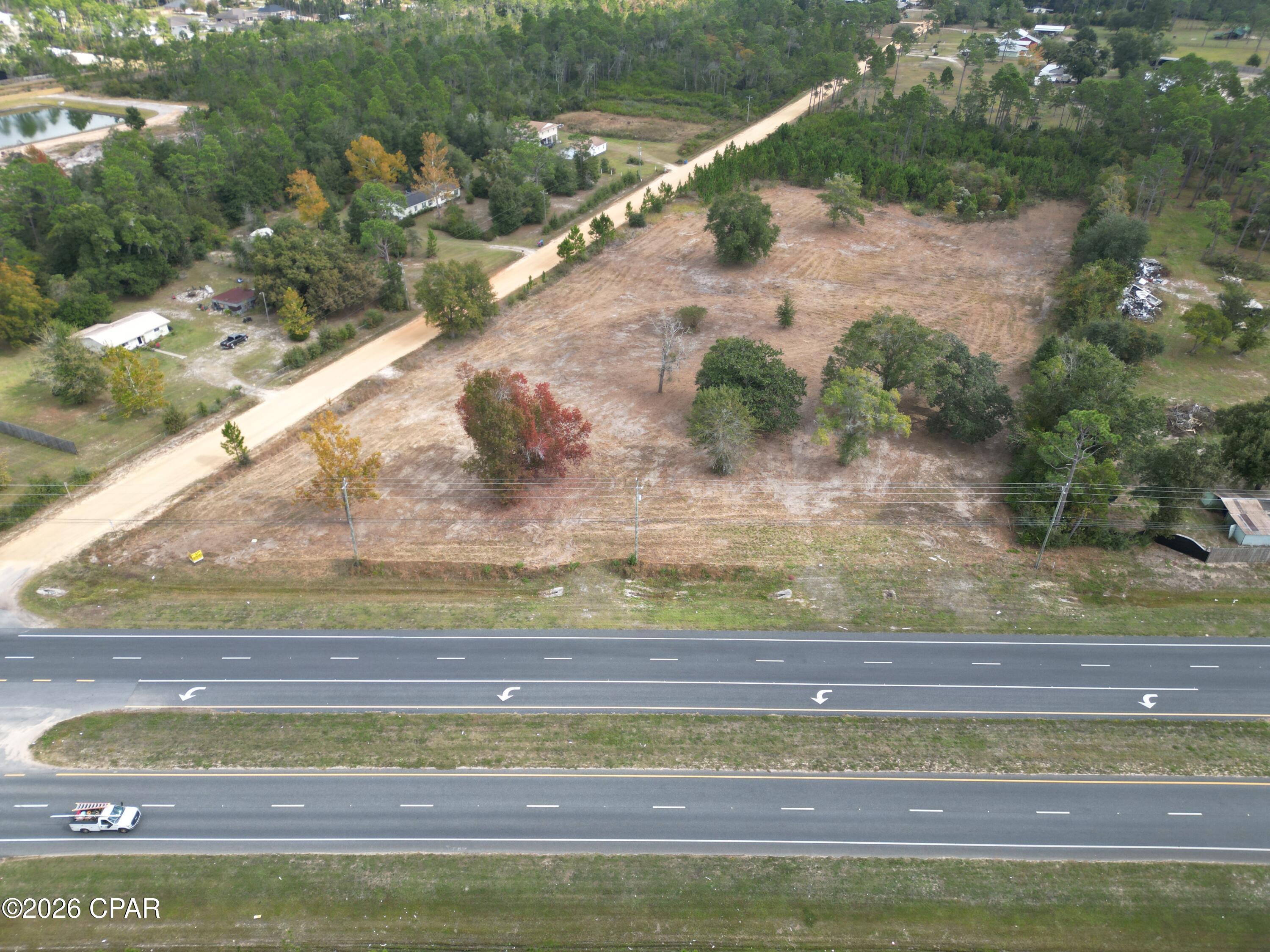 This 7.9± acre commercial property offers a rare opportunity to secure a highly visible site directly on SR Highway 77 in one of Bay County's fastest-growing corridors. With approximately 410 feet of highway frontage, this corner parcel provides excellent exposure and access for future development.
The property features two access points -- one directly from Highway 77 and a secondary entrance from Briggs Lane -- offering flexibility for traffic flow, customer convenience, or multi-tenant development. Its corner location further enhances visibility and accessibility.
Located in Southport, just three miles north of Lynn Haven and Panama City, the property is surrounded by established neighborhoods and increasing residential development in the area. As the population continues to grow, demand for convenient retail, service, medical, and professional businesses is expected to follow.
This site would be well suited for a neighborhood retail center, restaurant, medical offices, contractor services, equipment sales, storage facility, or other commercial ventures that benefit from strong traffic counts and easy access. The neighboring sand pit also supports ongoing construction activity in the region.
With strong highway exposure, dual entry points, and continued growth surrounding the site, this 7.9± acre parcel offers flexibility and long-term potential in a thriving location.
Position your business where growth is already underway! Contact us today for more information.  
Key Features:
*Development-ready acreage
* In the direct path of expanding commercial and residential development 
* Near established neighborhoods, new communities, and a planned retirement development.
* Just 3 miles to Lynn Haven/Panama City and approximately 10± miles to Northwest Florida Beaches International Airport.
