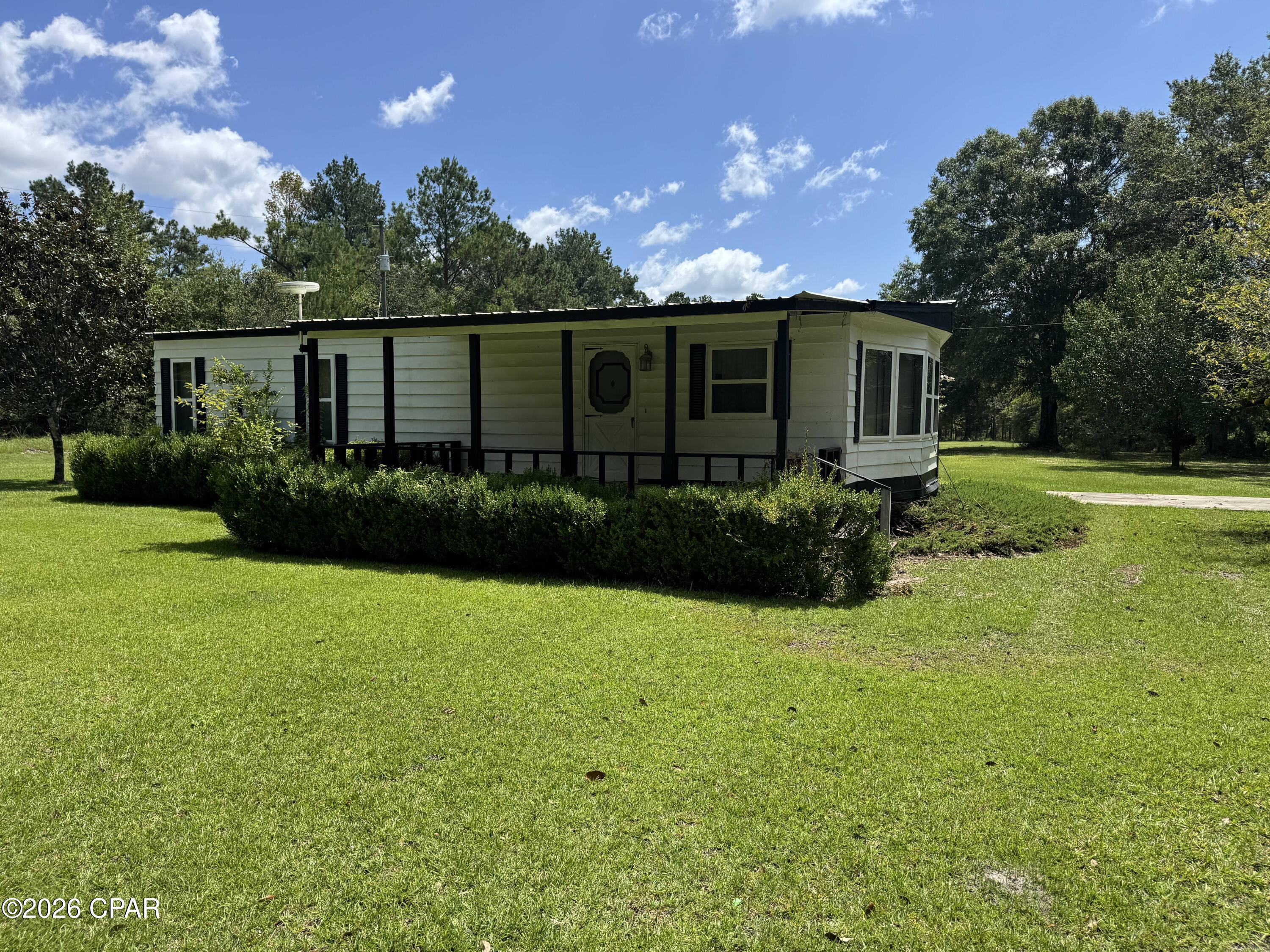 Escape to peaceful country living with this manufactured home situated on approximately 3.01 acres in Holmes County. This property offers plenty of space for gardening, recreation, or simply enjoying the quiet surroundings. The home features over 1,000 square feet of living space and is conveniently located just minutes from Graceville while still providing the privacy of rural living. Whether you're looking for a primary residence, an investment opportunity, or a weekend retreat, this property offers endless potential. Schedule your private showing today!
