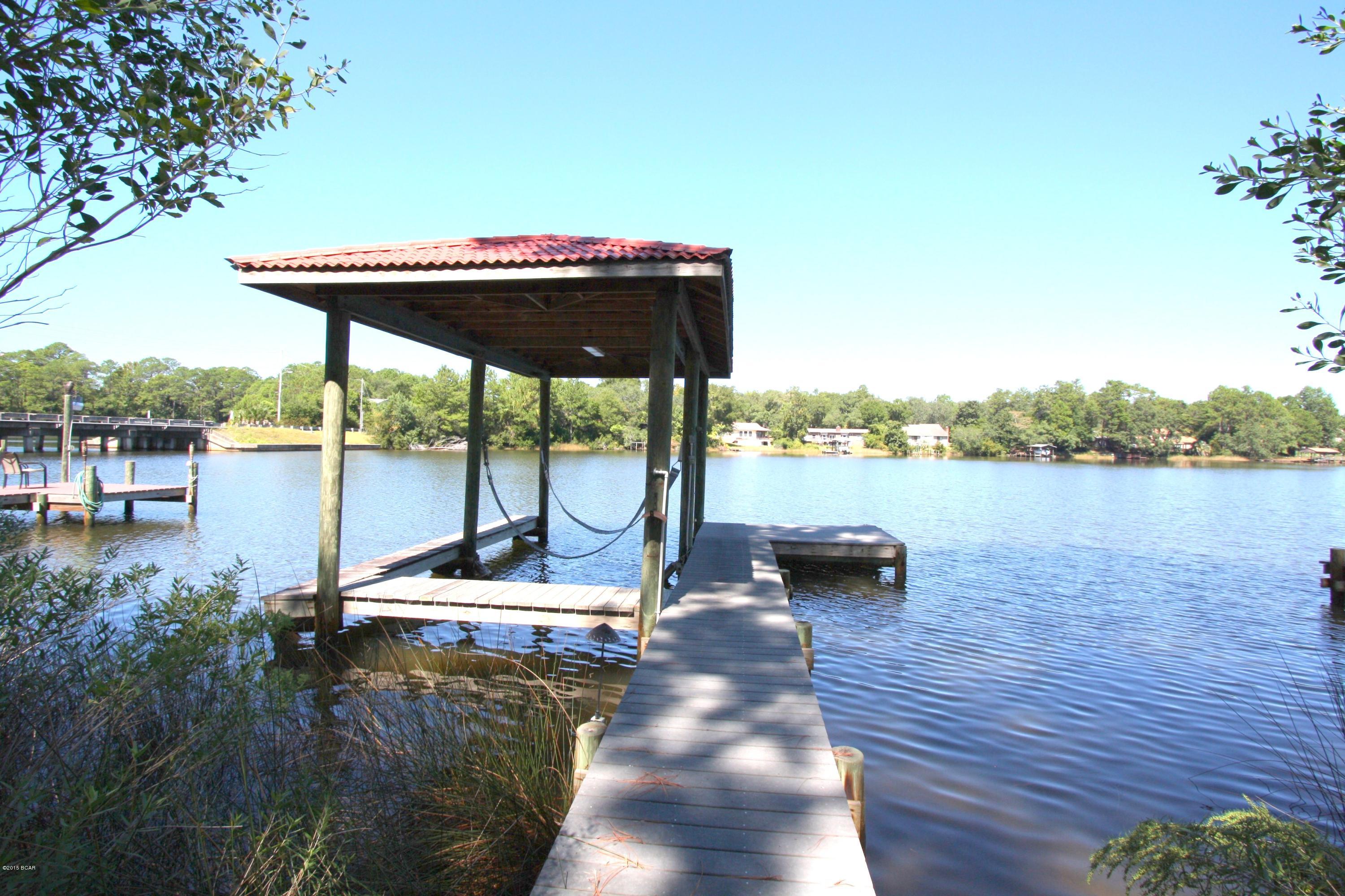 Waterfront living at it's best! Imagine yourself on the deck with a morning cup of coffee at the sunrises. Do you have a boat? If not, get one! This wonderful townhome right on Callaway Bayou has boat dock and boat house that can hold an 18 ft boat. Boat house even has tile roof to match home. This newly painted inside and out HomePath property features Great room with wood beams, unique lighting and soaring ceilings, and bay window for more open feeling and light from the awesome water views, stainless steel appliances and refinished cabinet doors in the kitchen, brand new carpet everywhere where there is carpet, both bathroom tubs and surroundings were re-glazed! Home has an oversized one car garage, hurricane shutters on main windows, fully fenced backyard. These are spacious units for easy living on the water and won't last long. Call your Realtor today! Age, Square Footage, and room sizes approx., if important please verify.