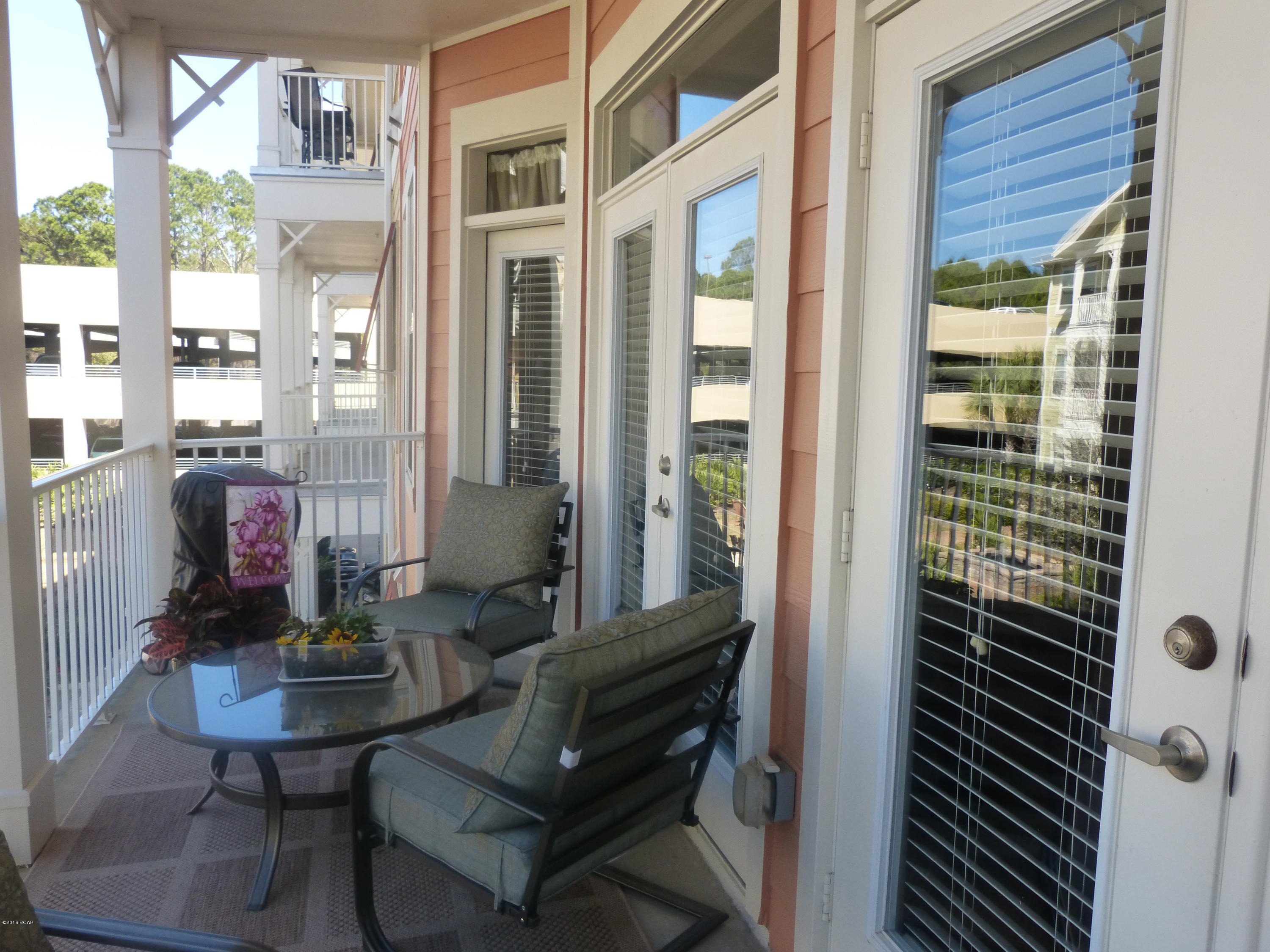 Best condo value in PCB. Second floor condo in desirable Island Reserve, an exclusive gated community. Non smoking unit. Same level garage parking with a private balcony overlooking the serene courtyard. Elevator in building. Beautifully decorated with custom paint, window treatments and unique fixtures. Unfurnished. Includes stainless steel appliances, granite counter tops, bamboo floors, 10 ft. ceilings with crown molding and chair railing. Lots of shelving added and great storage. Move in ready.  Amenities include clubhouse & recreational facilities, 1 acre resort style lagoon pool with rock waterfall, fitness facility, indoor basketball court, media center and conveniently located to shopping, restaurants and the beach. Age, SF and room sizes are approx. Please verify if important.