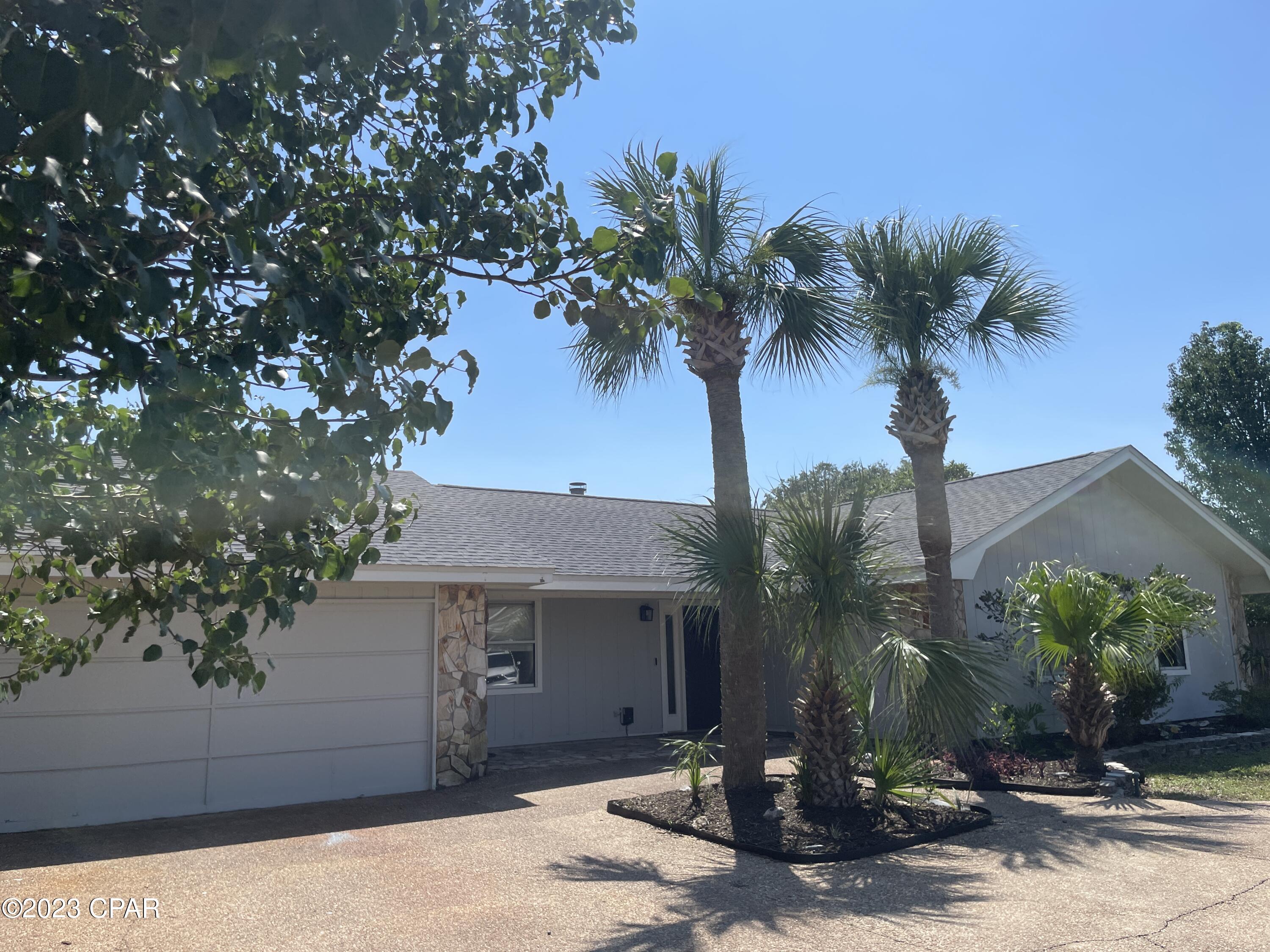 Quiet cul-de-sac location with NO HOA! and SHORT-TERM RENTALS ALLOWED!  Over one-third acre, plenty of room for boat parking with privacy-fenced backyard and covered patio!  This 3BR/2BA offers  5 year-old roof, updated kitchen and baths plus 400 sq. ft. bonus room...perfect for craft room, man cave or indoor she shed!  Kitchen offers granite countertops, stainless appliances.  New vinyl plank flooring in living area plus wood-burning fireplace for cozy winter nights!  5 minutes to Grand Lagoon and the beach!  Owner has termite bond too!