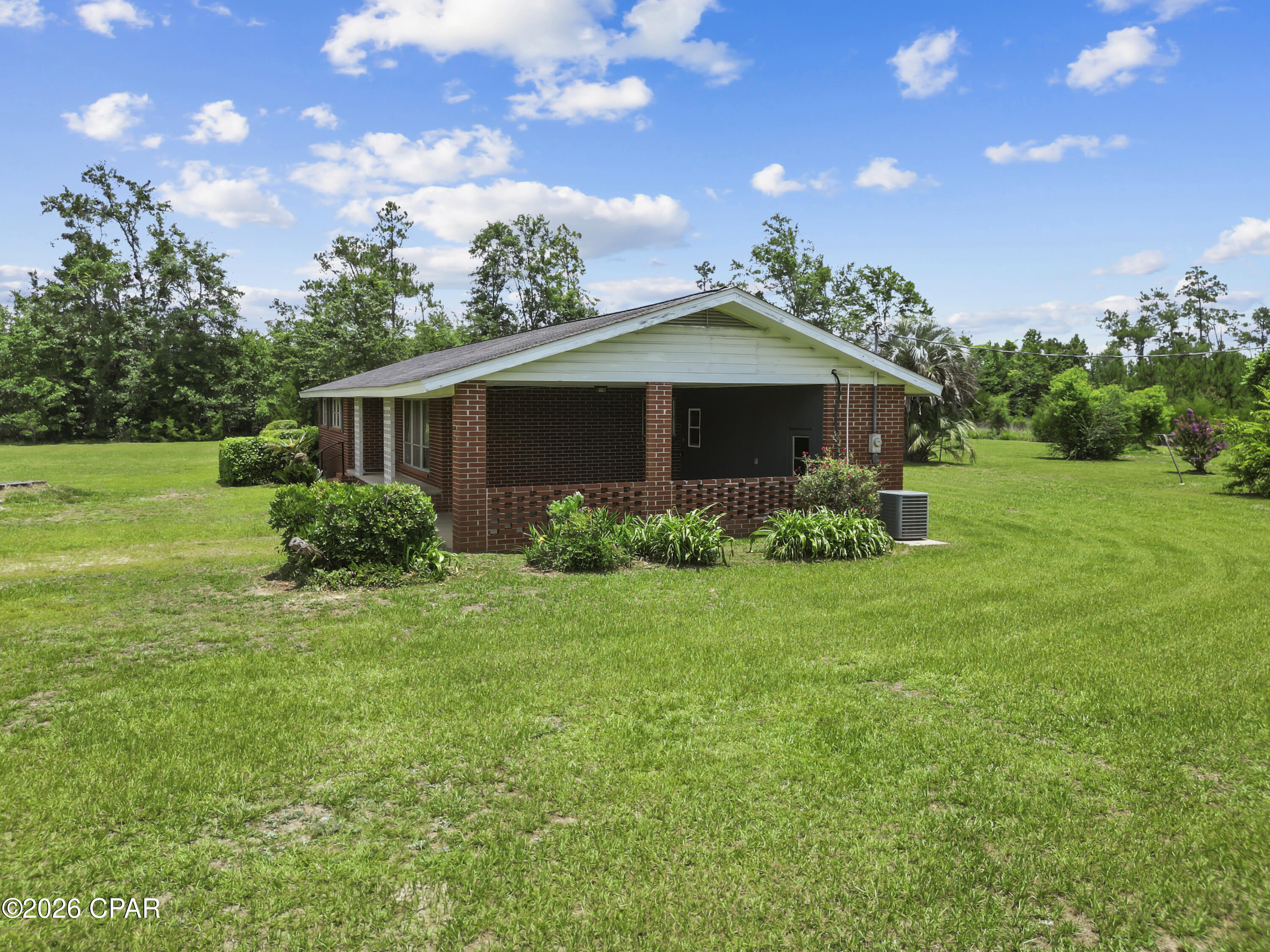 Situated on 10 acres in the Florida Panhandle, 19395 SW Matthew Wood Road offers the space, privacy, and flexibility you've been looking for. This 3-bedroom, 2-bath brick home features approximately 1,490 square feet of living space, beautiful hardwood floors, and a roof that was replaced approximately 7.5 years ago.

Picture yourself enjoying quiet mornings overlooking your acreage, spending afternoons gardening, exploring your property, or simply appreciating the extra room to spread out. The combination of open land and wooded areas provides endless possibilities for outdoor enjoyment, hobbies, and recreation.

Inside, you'll find a comfortable layout designed for everyday living. The hardwood floors add warmth and character, while the home's practical floor plan provides space to gather, relax, and make lasting memories.

Conveniently located approximately one hour from Panama City and about one hour and twenty minutes from Dothan, Alabama, this property offers a balance of country living and access to shopping, dining, healthcare, and employment opportunities.

If you've been searching for a property with acreage, room to roam, and the opportunity to enjoy a more relaxed pace of life, 19395 SW Matthew Wood Road deserves a closer look. Come experience the possibilities this property has to offer.