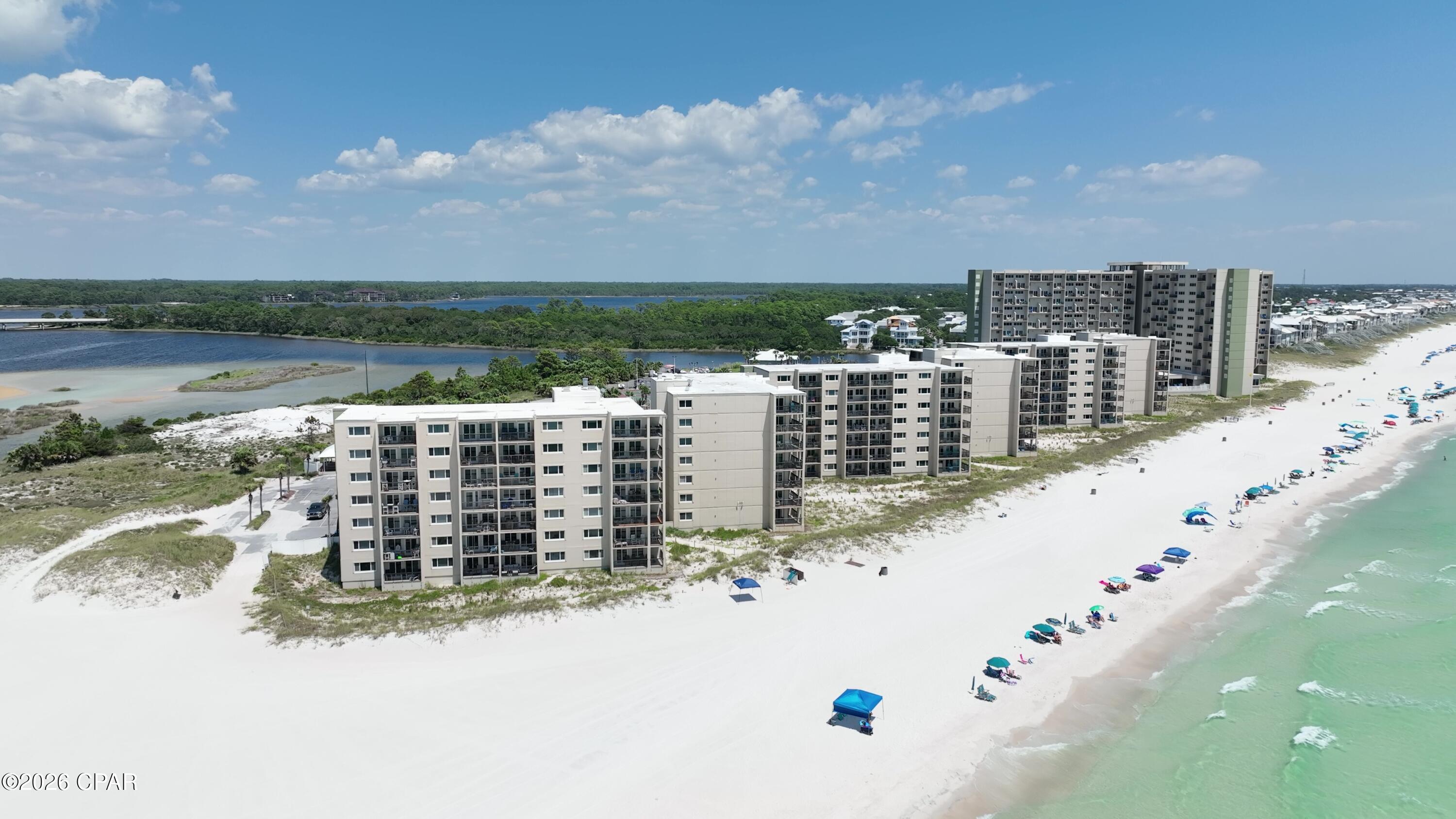 This beautiful townhouse style condo is located in the highly desirable Pinnacle port, a family-oriented resort tucked away from it all but still close to all the action, if desired. Featuring, direct gulf views off the dining and living room areas. Sit on the balcony off the living room and listen to the waves. The kitchen features nice appliances, including a full-sized refrigerator and granite counter tops. A half bath with a full-sized washer and dryer. Upstairs you'll find a guest bedroom with direct gulf front views. There is a queen bed as well as twin bunks, sleeping a total of 4. The second bedroom has a king bed and en-suite. The balcony off the second bedroom has views of Lake Powell and the bridge leading into Walton County.

The resort has 2 pools, one that is partially covered for those hot beach days. It is also heated in the cooler months for year-round enjoyment. 2 saunas are available for your use. Pinnacle Port has 2 grilling areas located throughout the property one of them viewable from the living room balcony. They have a beach side playground, boat slips and docks for fishing. There are tennis/pickleball and bocce ball. All of this in a safe, gated community lined with sidewalks and palm trees for bike riding.