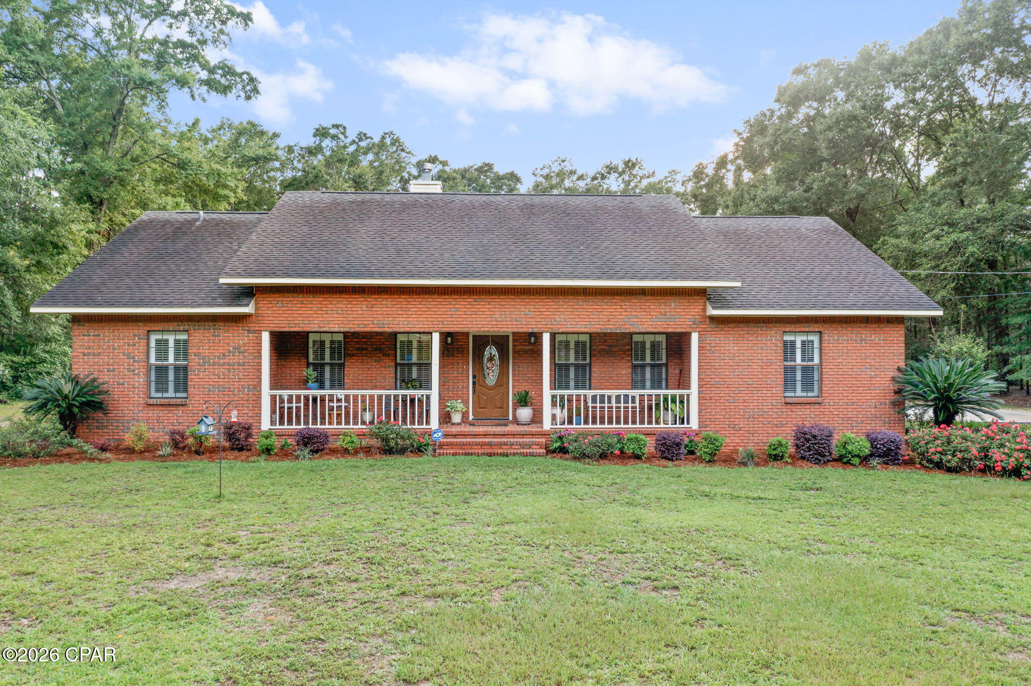 Welcome home to one of the most sought-after neighborhoods in the area--Nearing Hills! Nestled among mature shade trees on a beautifully maintained homesite, this well-kept 3-bedroom, 2-bath brick home offers the perfect combination of comfort, functionality, and outdoor living. Step inside to discover a spacious floor plan highlighted by a large living room with soaring vaulted ceilings, abundant natural light, plantation shutter blinds, and a stunning brick fireplace that serves as the heart of the home. The kitchen features quartz countertops, stainless steel appliances, ample cabinetry, and a convenient breakfast bar overlooking the adjoining dining area, creating an inviting space for both everyday living and entertaining. The spacious primary suite offers a relaxing retreat complete with a walk-in closet and an en-suite bath featuring double sinks, a dedicated makeup vanity, and a tub/shower combination. Two additional bedrooms and a full guest bath provide comfortable accommodations for family and guests, with one guest room currently serving as a home office. Adding both convenience and peace of mind, the home is equipped with a whole-house Generac generator, providing reliable backup power during outages and helping keep your home running smoothly year-round. Outside, you'll find plenty of space to enjoy the Florida lifestyle. Relax on the expansive deck surrounding the above-ground pool, or take advantage of the property's impressive outbuildings. An attached two-car carport adds convenience and covered parking for everyday living. The detached garage provides excellent space for storage, hobbies, or a workshop, while the 48x32 open pole barn offers ample room for RVs, boats, tractors, equipment, or recreational vehicles. A portable storage shed provides even more flexibility for organizing tools and outdoor gear. Surrounded by the natural beauty and peaceful atmosphere that make Nearing Hills so desirable, this property combines timeless charm, practical amenities, and exceptional outdoor space in a location that remains convenient to shopping, dining, schools, and everyday necessities.