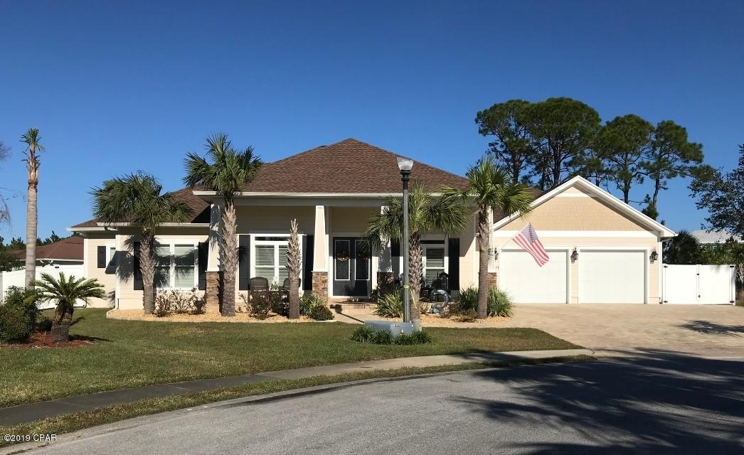 Southern Coastal, CRAFTSMAN Style.  2 years new,beautiful CUSTOM built home in the highly desirable gated/waterfront/marina community of Dolphin Bay....Located at the east end of PCB, very private cul-de-sac with great bay breezes...Large front porch and double entry doors welcome you into a grand open floor plan....9-11 ft ceilings, trays and coffered ceilings, crown molding and split bedroom plan.....porcelain tile floors throughout....Butlers pantry, custom cabinetry, stainless appliances...Large rear fenced yard with Tropical landscaping that borders a protected conservation area......36x24 covered/screened lanai for great outdoor living....