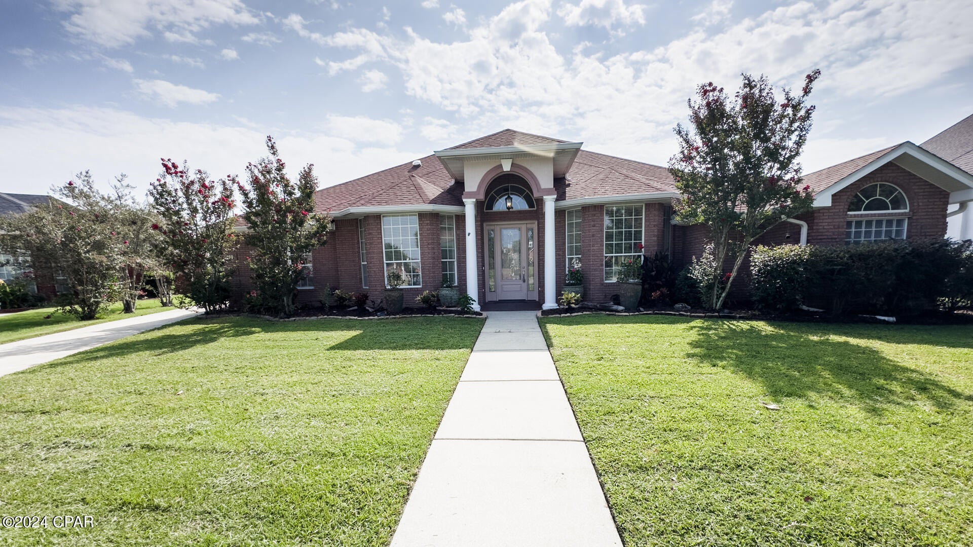 This is a newly remodeled all-brick Executive golf course and pool home located in The Landings subdivision in Lynn Haven. This is a custom-built home that has recently been upgraded/remodeled with brand new master bathroom with soaking tub and large stand-up shower, Calacatta quartz countertops throughout, new flooring in all bedrooms/office/bathrooms, new plumbing fixtures, fully remodeled full hall bath with large tub and tile surround and the list goes on. As you step inside, you'll be greeted by an abundance of natural light, palatial columns, high ceilings, moldings, and a spacious layout. The heart of the home is a beautifully appointed kitchen with stainless steel appliances, maple cabinets, breakfast bar and breakfast nook. The living room features a fireplace, built-ins, and large windows that provide scenic views of the pool and golf course. The patio and saltwater pool are fully enclosed and there is plenty of room for entertaining outside.  The master en-suite features a huge walk-in closet, private access to the pool area, and a full bathroom. The three additional bedrooms have plenty of room for sleep and study and have access to two additional full bathrooms. One bedroom located at the back of the home is perfect as a mother-in-law or guest suite with its own entrance and the full bath conveniently located just steps away! This home also features a large, dedicated laundry room and a large pantry. The Landings is a sought-after neighborhood within 1 mile of Bay Haven Charter School, Nature Walk Golf Club and conveniently located close to grocery stores, local restaurants and shopping.