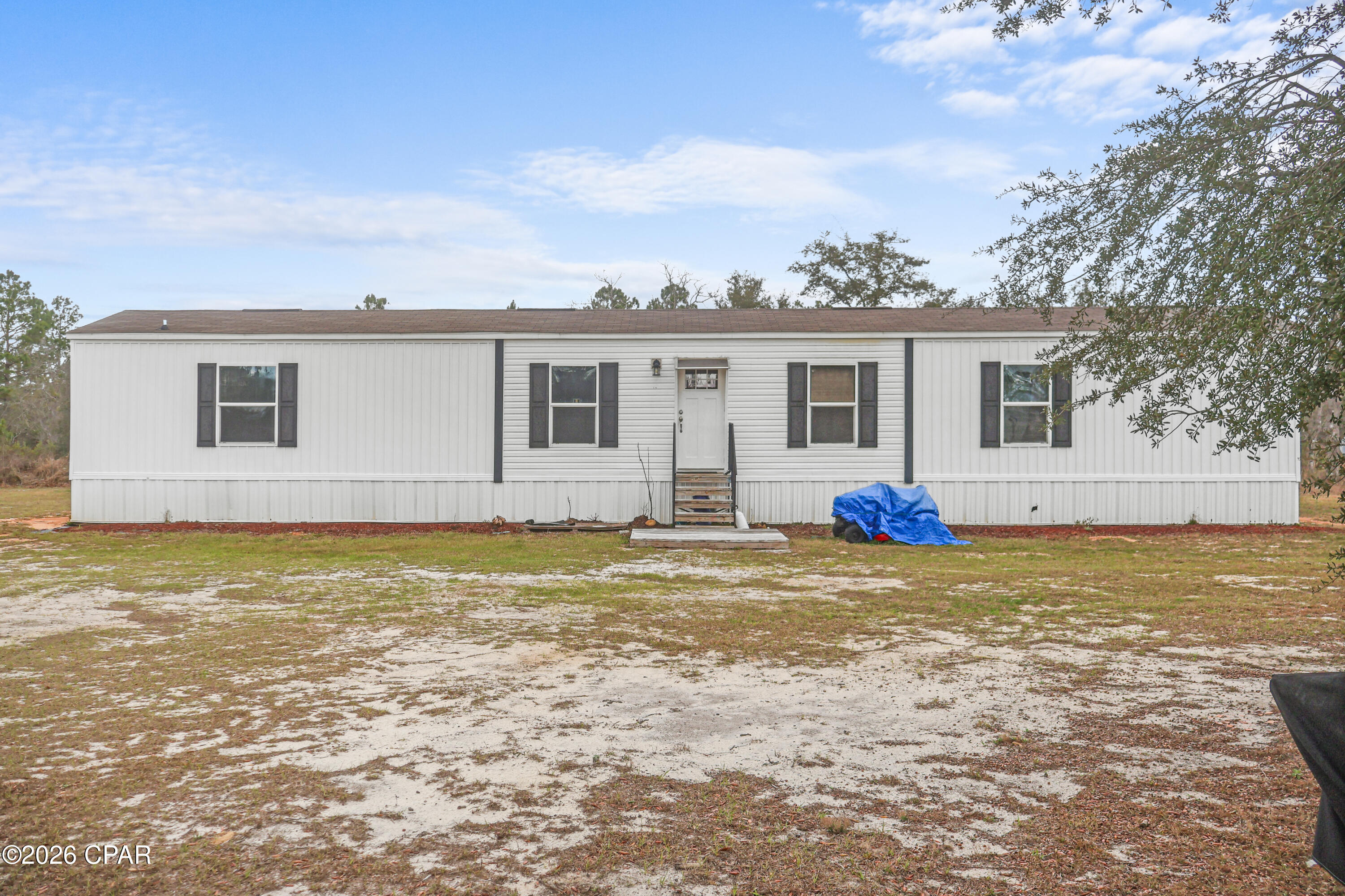 !!Price Improvement!!

Welcome to 21835 NW Lake McKenzie Blvd in Altha, Florida--a place where you can slow down, spread out, and enjoy country living while still being close to everything you need.

Built in 2020, this 3-bedroom, 2-bath home offers 1,155 sq ft of comfortable living space designed for easy living. Step inside to an inviting open layout with a spacious kitchen, center island with seating, and a bright living area that makes it easy to gather with friends or relax after a long day. The layout flows naturally, giving you both comfort and function.

Outside is where the property truly shines. Situated on 5 acres, most of the land is already cleared with scattered trees, giving you room for a garden, workshop, animals, outdoor hobbies, or simply enjoying the open space and quiet surroundings. There is no flood zone, no HOA, and no deed restrictions, giving you the flexibility to use the land in ways that fit your lifestyle.

You'll enjoy the peaceful setting while still being conveniently located--about 30 minutes to Marianna and roughly 1 hour to Panama City Beach or Dothan, Alabama for shopping, dining, and entertainment.

If you've been looking for space, freedom, and a move-in ready home in North Florida, this property offers the opportunity to make it happen.

Schedule your showing soon and come see how life on Lake McKenzie Blvd could fit your plans.