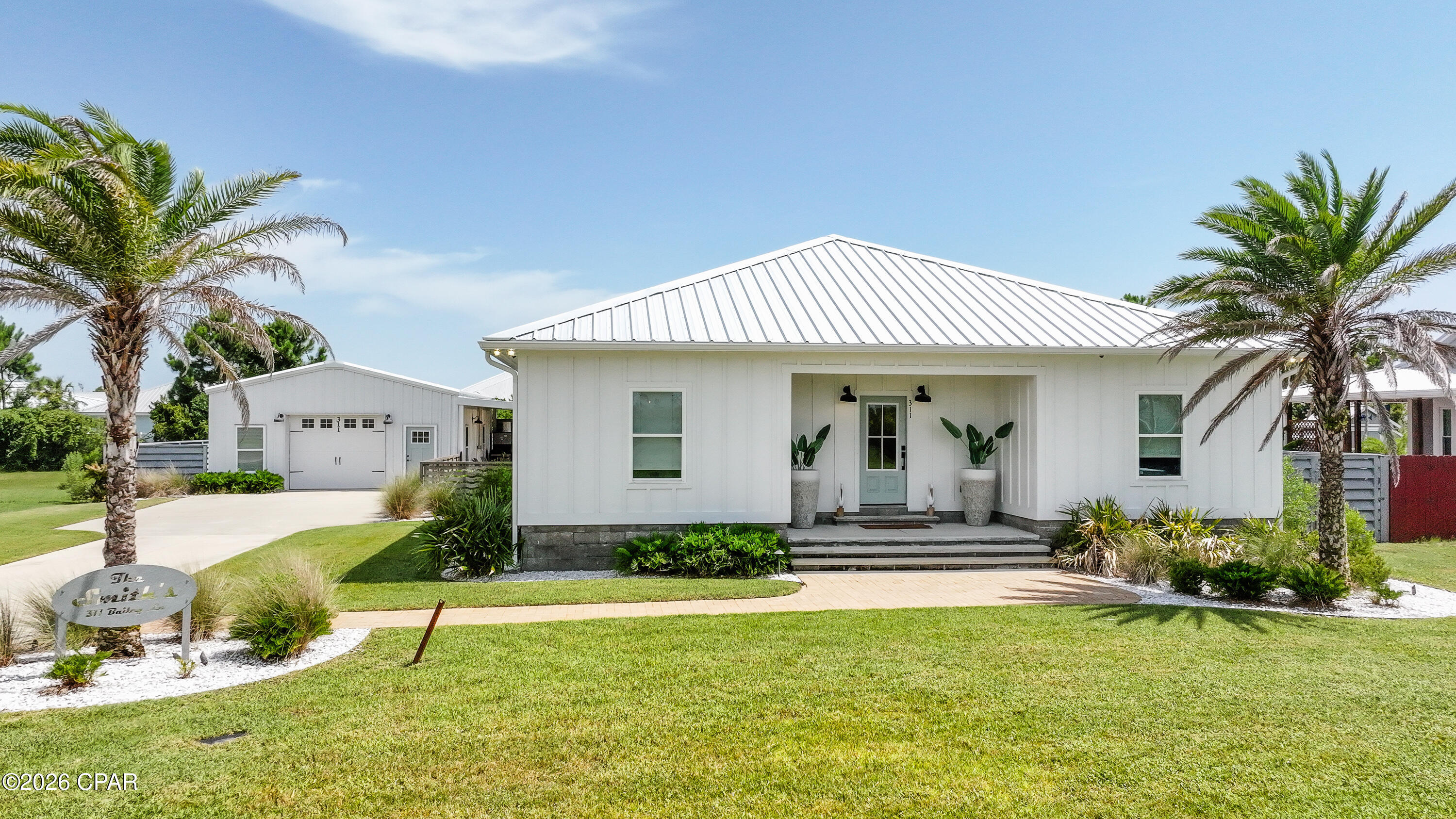Experience custom coastal living at 311 Bailey Lane in Mexico Beach. Situated on a beautifully landscaped 0.491-acre homesite in desirable X Flood Zone, this thoughtfully upgraded property features a 1,596-square-foot main residence, a separate 960-square-foot guest house, and an inviting pool designed for effortless outdoor living. The main home showcases custom cabinetry in the kitchen and primary bathroom, an oversized primary suite, a spacious shower, spray-foam insulation, and carefully selected finishes throughout. Outside, the custom bar creates the perfect setting for entertaining after a day at the beach, while poured concrete, professional landscaping, custom galvanized metal fencing, and stainless-steel fencing add both function and distinctive style. The detached guest house offers one bedroom and one bathroom, along with a loft area featuring custom built-in bunk beds--ideal for visiting family, extended stays, or a private retreat. Spray-foam insulation has also been installed in the guest house for added comfort and efficiency. Located just minutes from the beach, this beautifully customized Mexico Beach property offers the space, flexibility, and relaxed atmosphere buyers seek in a vacation home or full-time coastal residence. From the private pool and outdoor entertaining areas to the separate guest accommodations, every detail has been designed to make the most of the Forgotten Coast lifestyle.